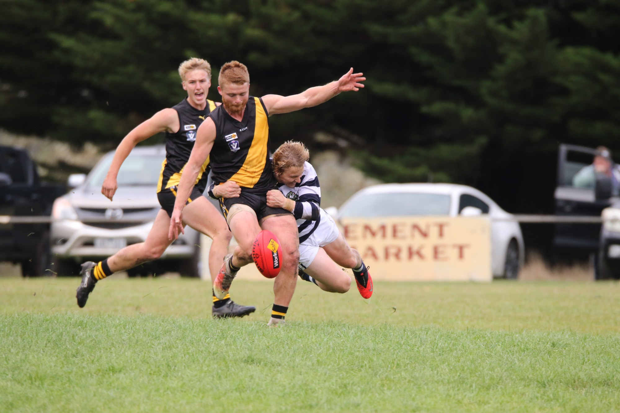 Tom Leishman powers through Jeremy Spokes’ tackle, while Tom Linquist looks on.