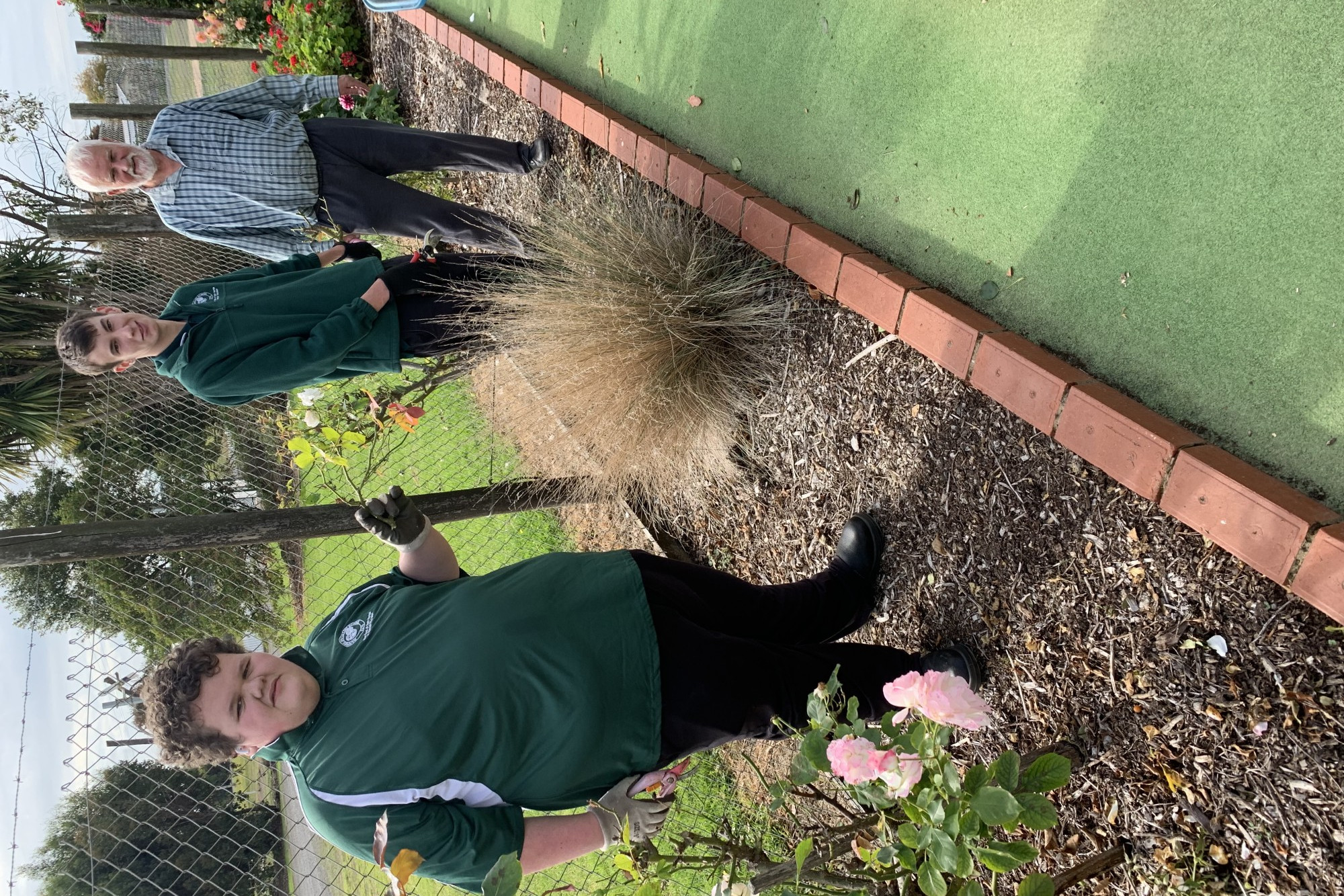 Rotary initiative: Students Jai and Michael work with Rotarian Graeme learning some gardening procedures.