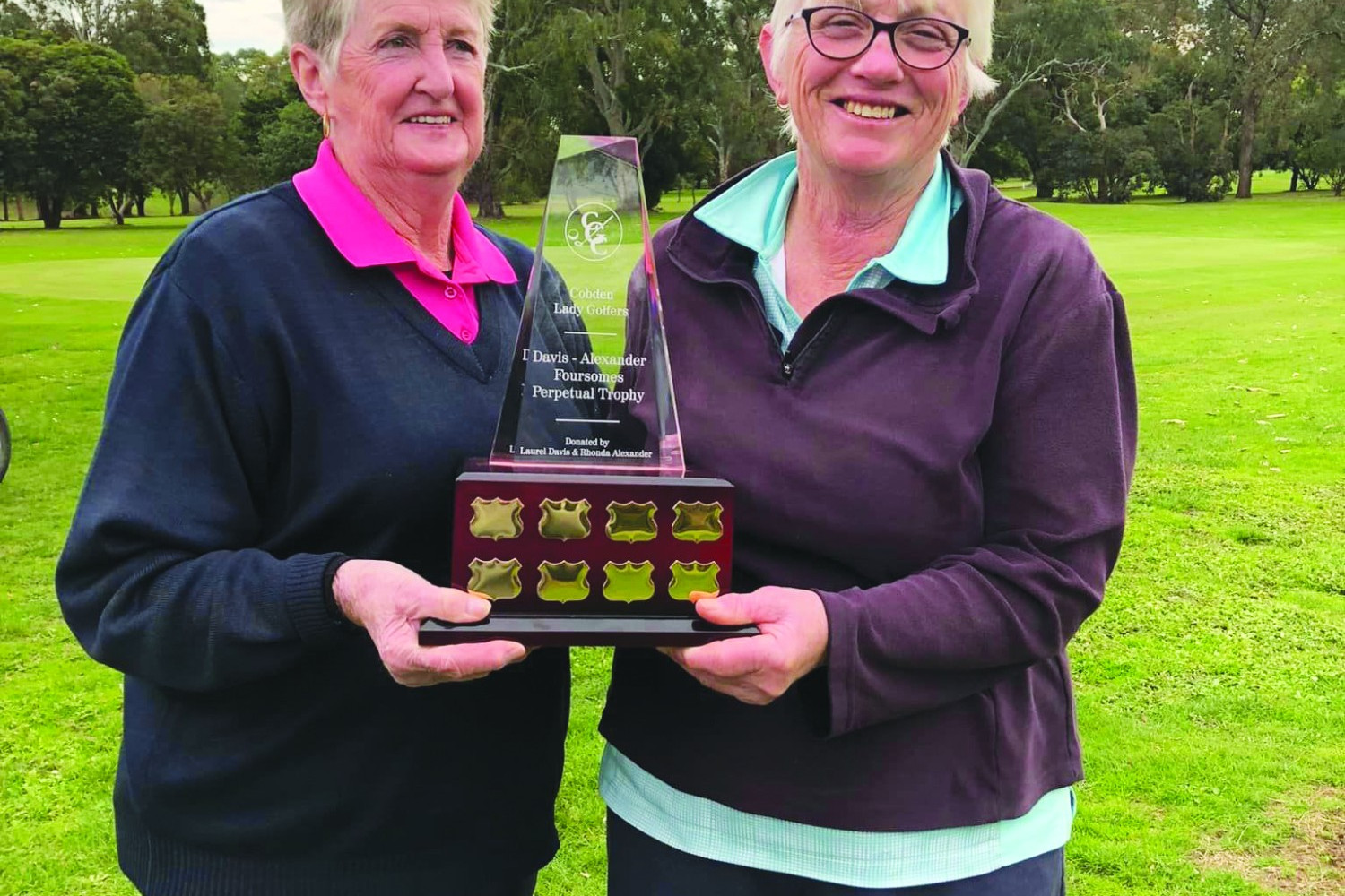 Inaugural winners Marie Smith and Pat Tickner hold aloft the Davis/Alexander foursomes perpetual trophy at Cobden Golf Course.