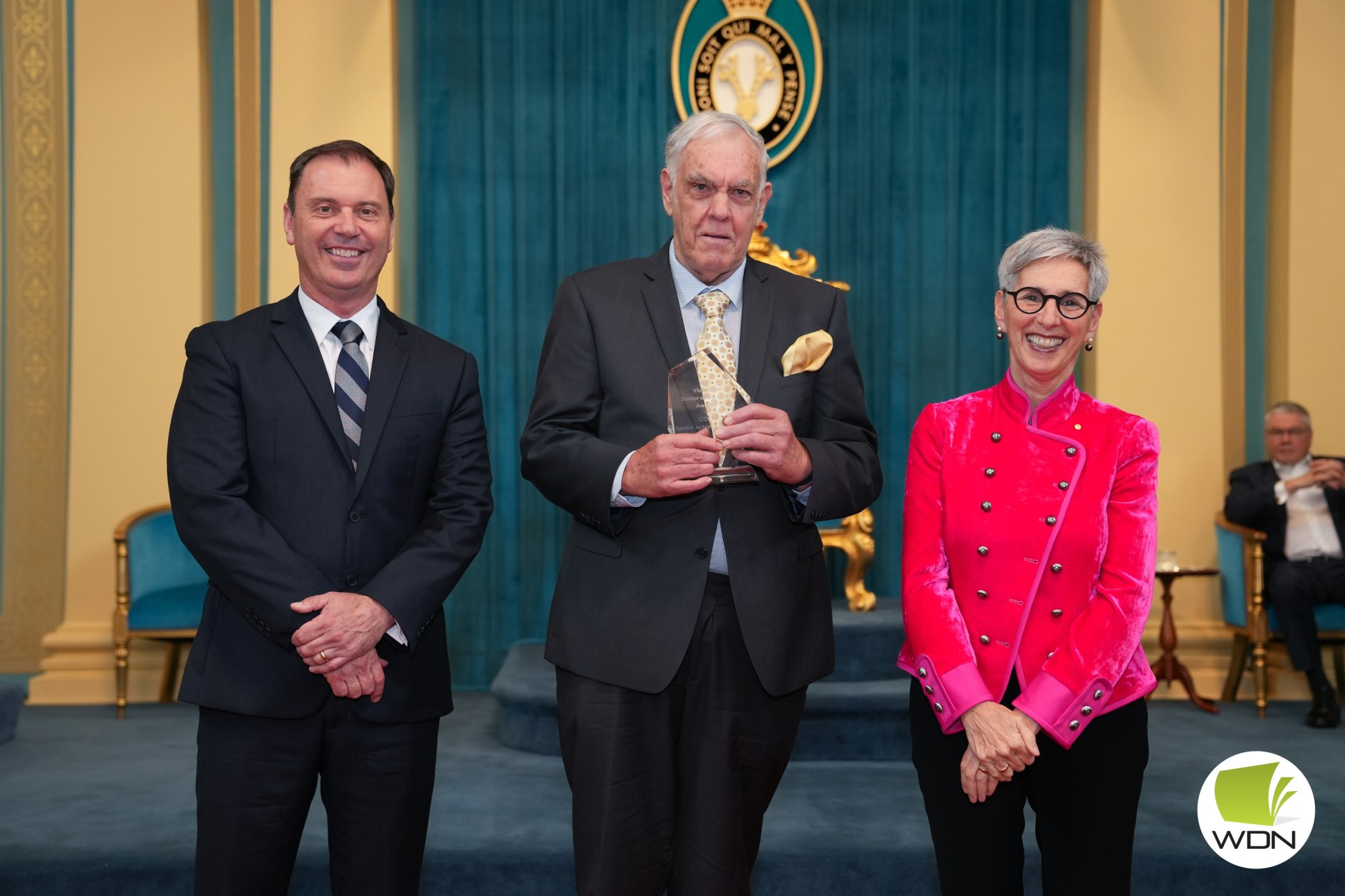 Congratulations: Minister for Disability, Ageing and Carers Colin Brooks (left) and Governor of Victoria Linda Dessau (right) present Timboon’s John Fox with the Council of the Ageing (COTA) Victoria Senior Achiever Award.