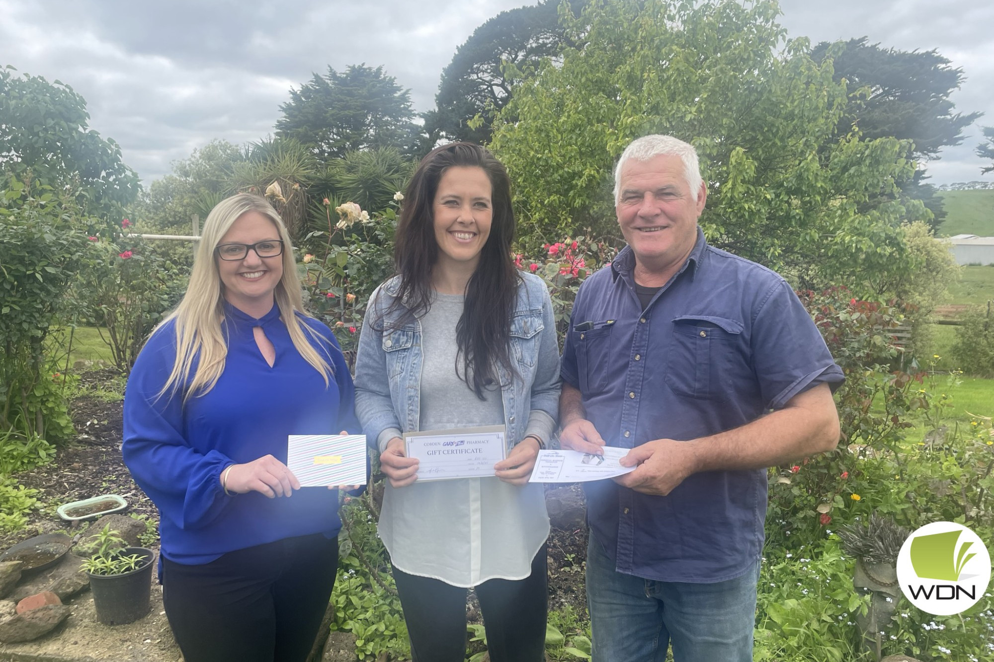 Helping out: Cobden business and economic development consultant Laura Hultgren presents Lauren Moorfield and John Baker with certificates for a good deed.