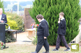 Hampden Specialist School students Michael and Ryan place a wreath. 