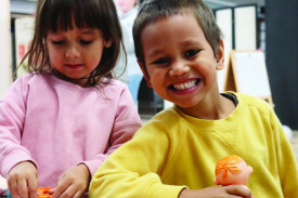 Shakya and Raymond Rankine play with playdough. 