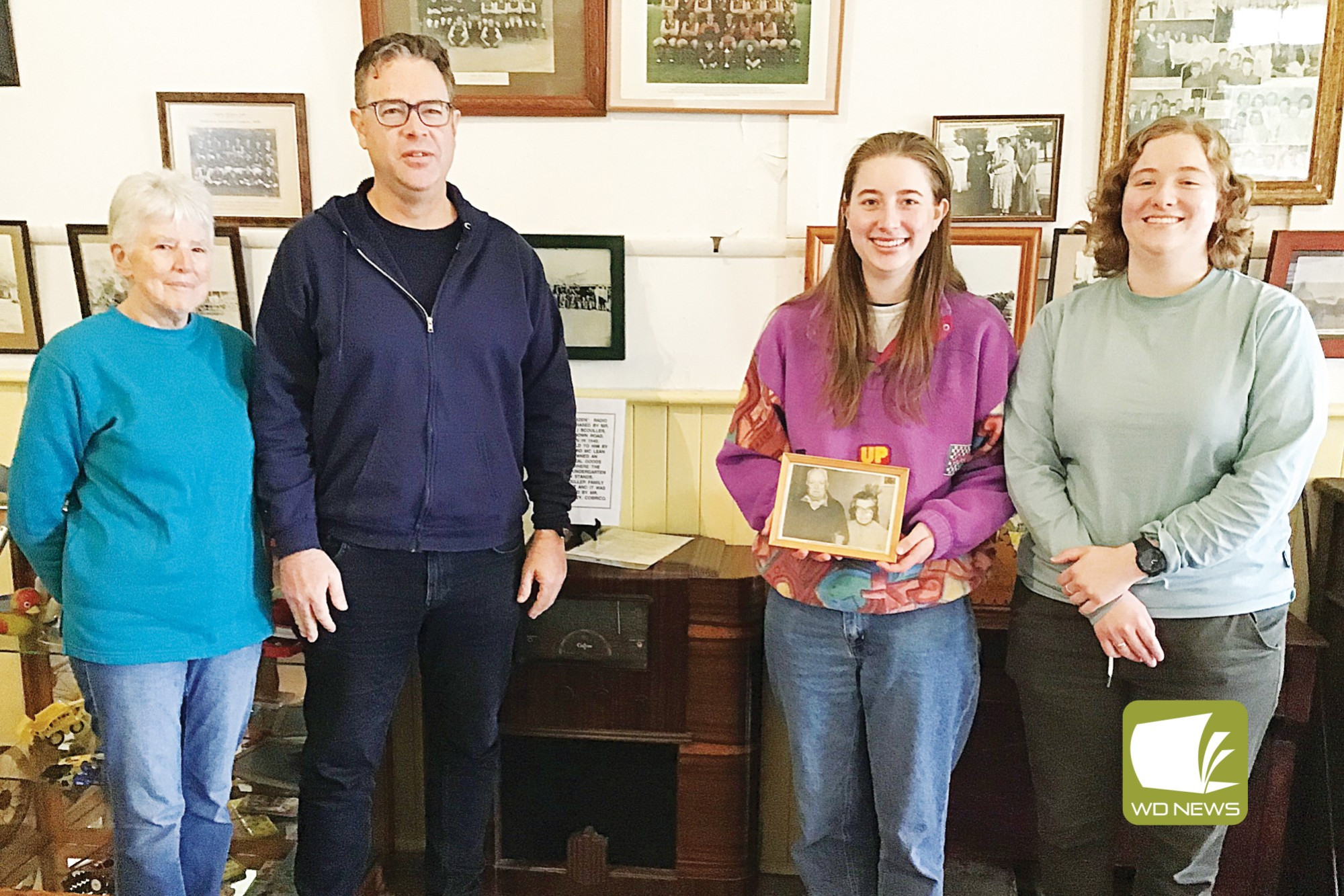 Revealing the past: Cobden Historical Society research officer Janet Wason with Paul Scouller and daughters Olivia and Alex who paid a visit to Cobden to learn about their family history.