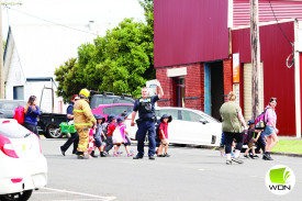 Cobden Police sergeant Craig Jenkins helps evacuate Cobden Kindergarten children after a gas leak. 