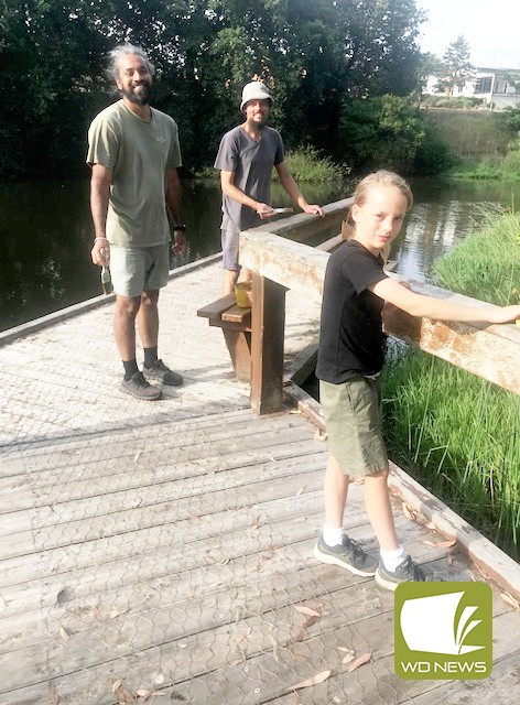 Gagan Singh, Luke Perris and Ruben Perris help out with sanding the bridge during a recent working bee at Lake Cobden.