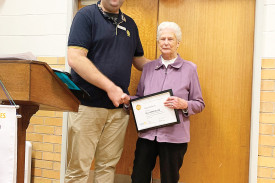 Joyce Roberts with Paul Harris Fellowship award next to David Childs. 