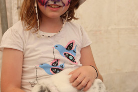 Evelyn Barake, 7, pets a rabbit and the animal nursery. 