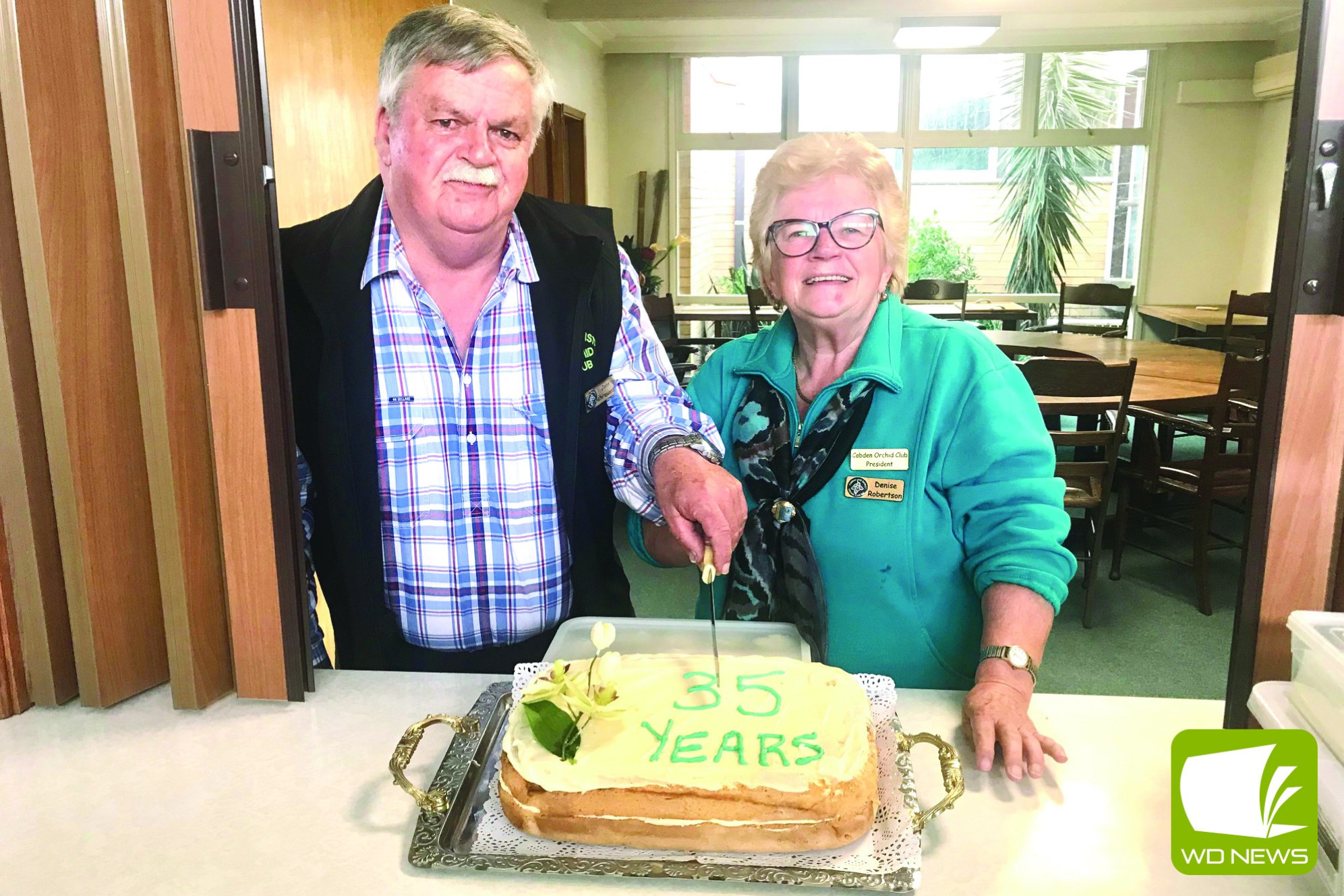 Cobden and District Orchid Club president Denise Robertson and club secretary John Whitewood cut the club’s 35th birthday cake.