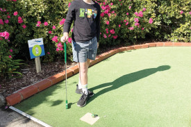 Emmett Gladman, 8, tries his luck at mini golf. 
