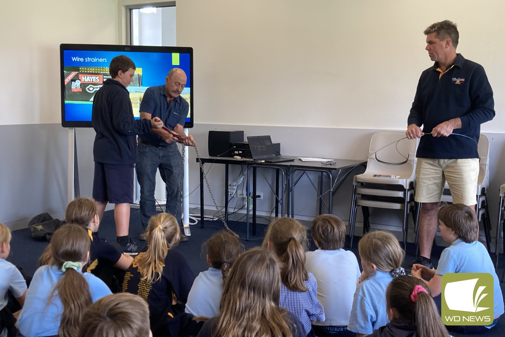 Local Timboon farmer Chris Mackenzie helps out in the class room giving Timboon P-12 School students a practical understanding in their Flood Maths unit.
