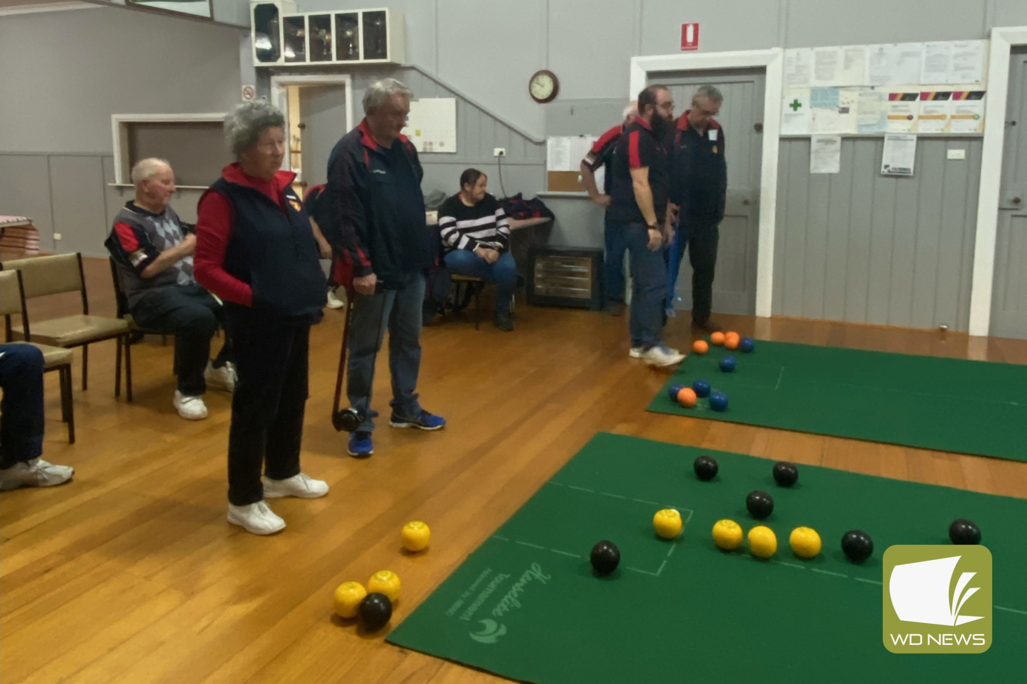 In Division 3 (far left), Glenormiston Third Maureen Bond and Timboon Lawn 5 Third Jim Mungean watch on as their skips bowl, while Division 1 (far right) action heats up with Glenormiston 1.