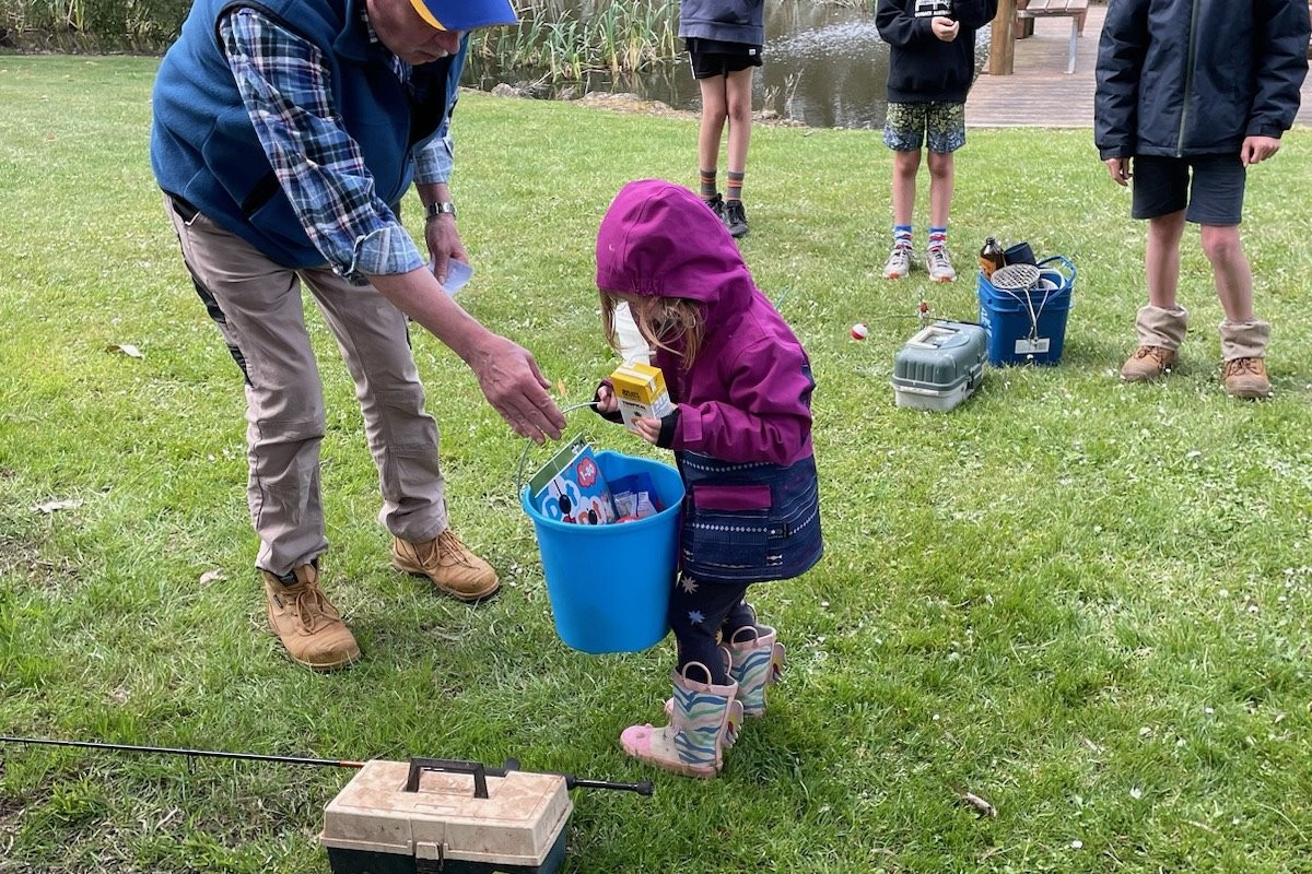 Young anglers: Simpson and District Lions Club president Russ Davis presents prizes to brother and sister Sophie and Liam for their efforts in the club’s junior fishing competition.