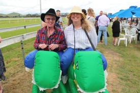 Dynamic duo: Mortlake’s Denise Arundell and Robyn Kelly embraced the silly side of the day by dressing up as jockeys on dinosaurs.