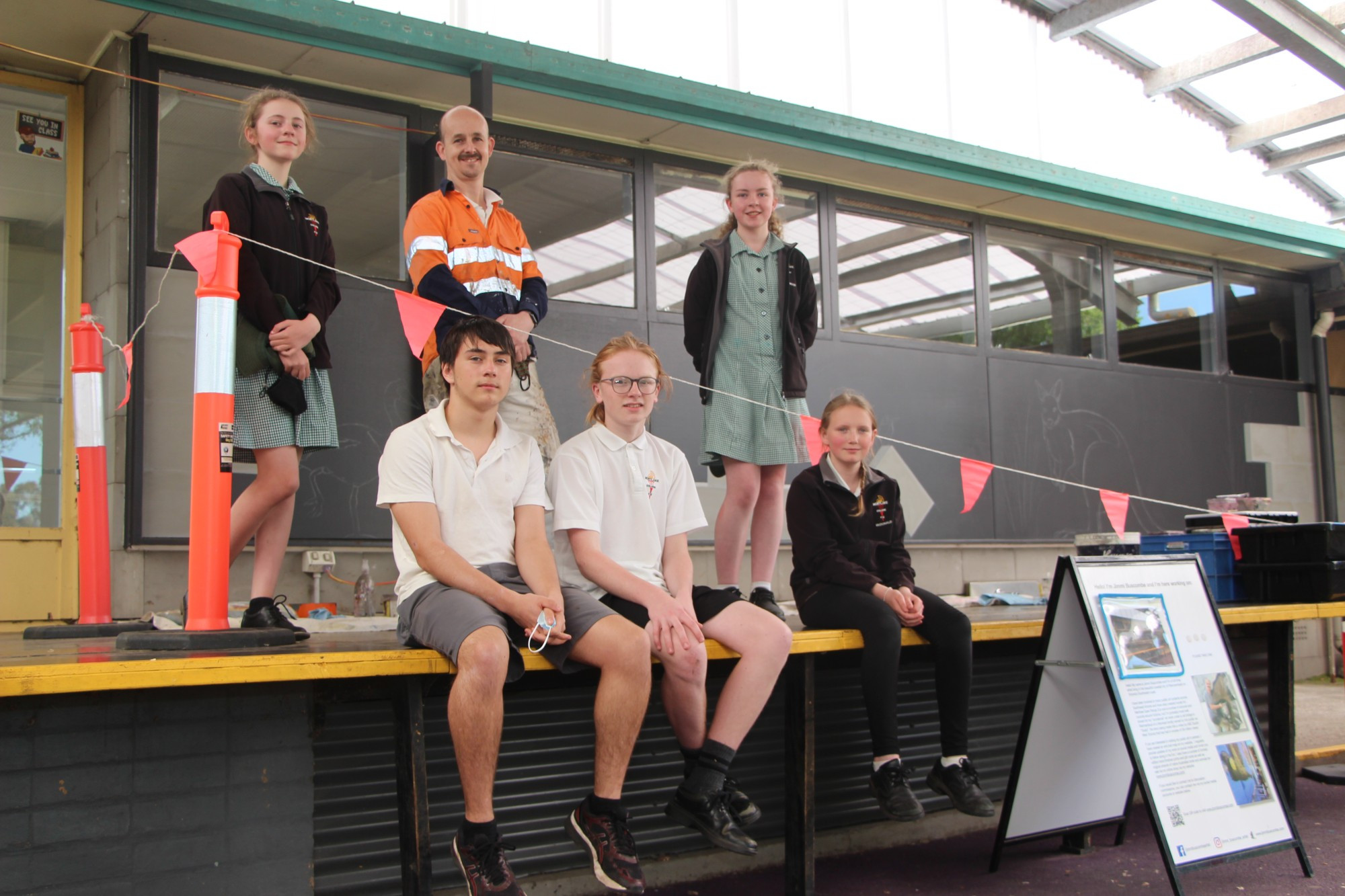 Getting creative: Prominent south west artist Jimmi Buscombe has brought his talents to Mortlake, spending this week painting a large mural at Mortlake College’s assembly area.