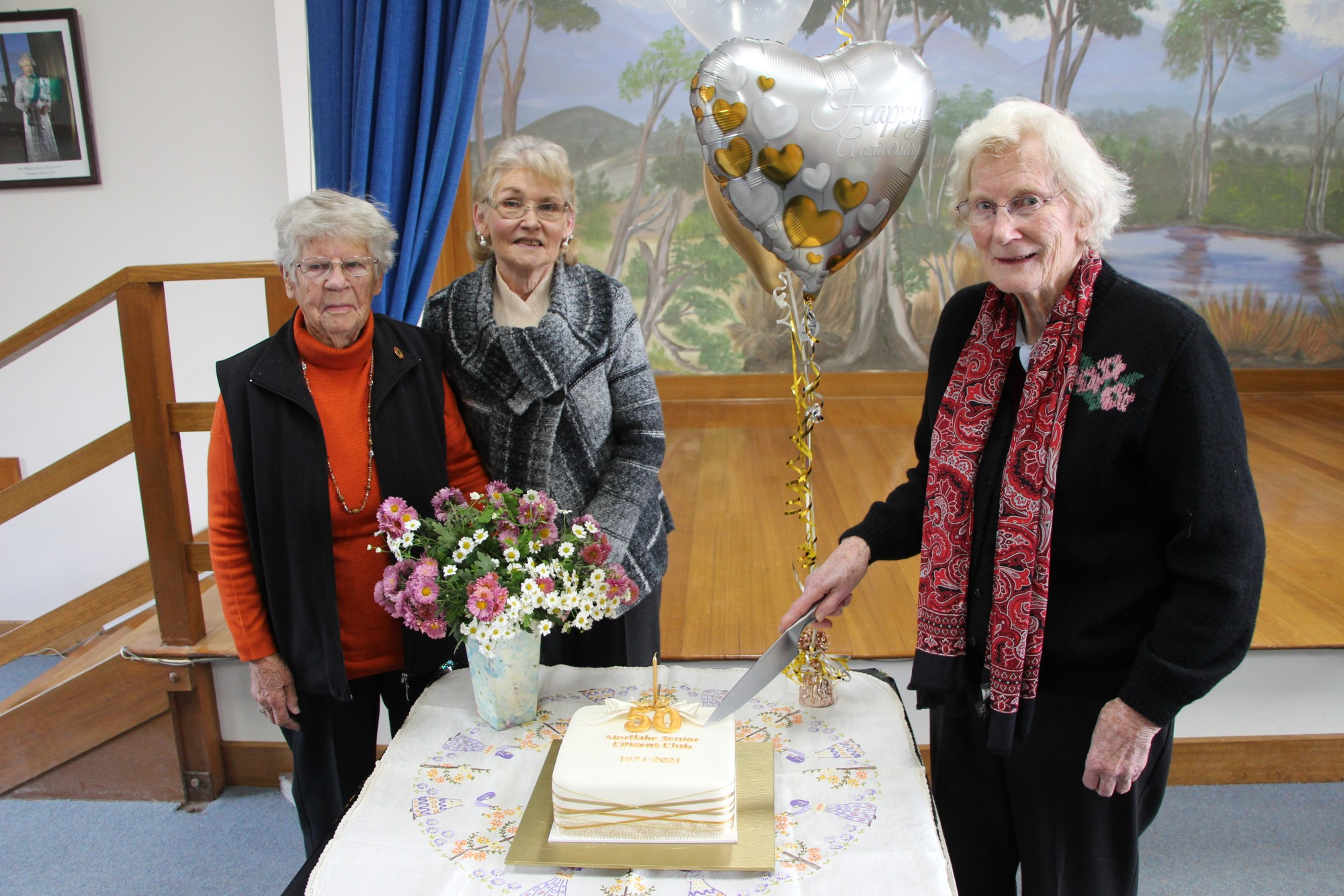 Happy birthday: Mortlake Senior Citizens Club’s longest serving active members, Rae Risk (left), 34 years, and Lorna Turnbull (right), 24 years, were joined by club president Jeanette Feeney to cut the cake celebrating the club turning 50.