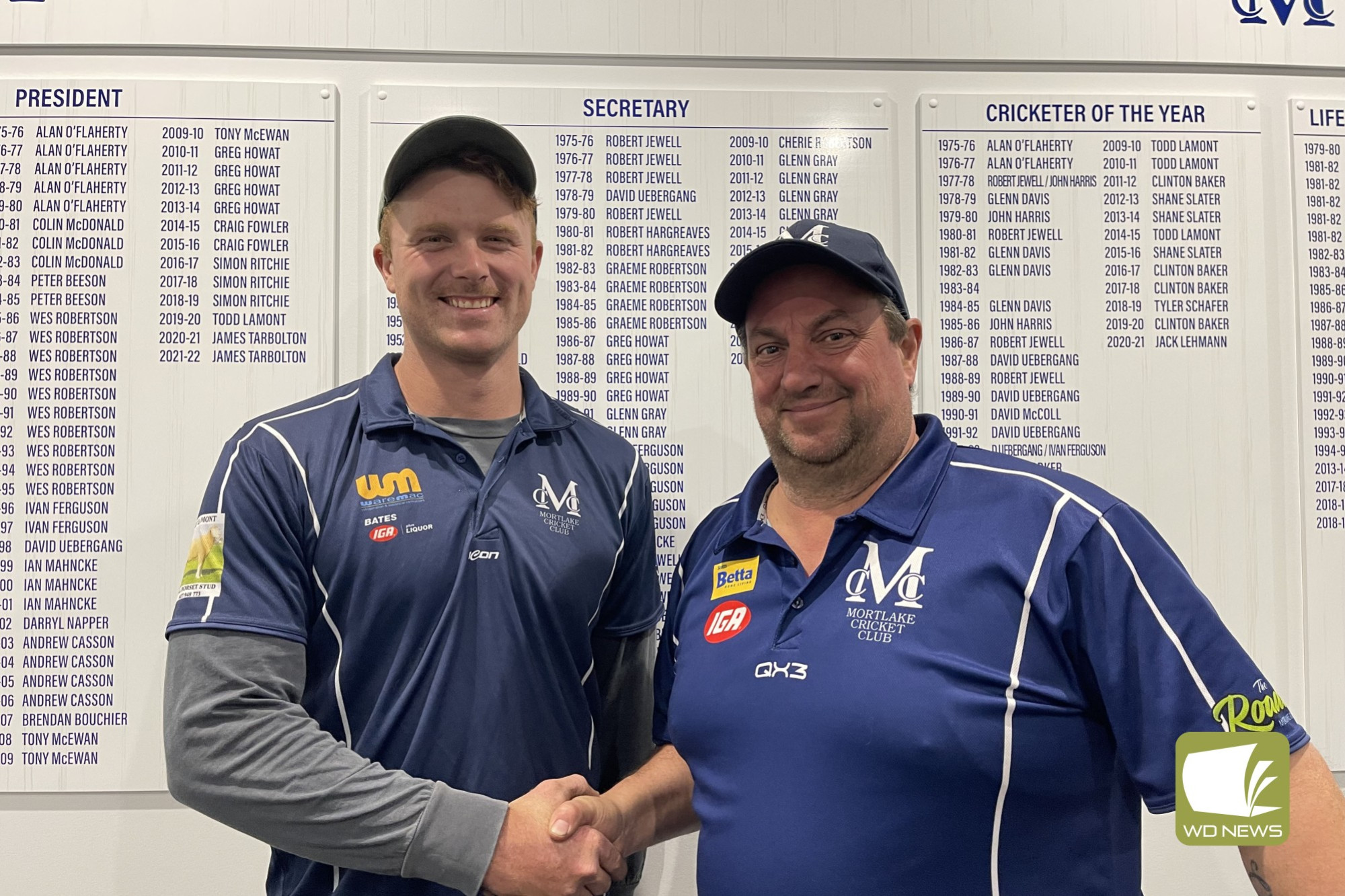 Newly appointed seniors coach Lachlan Wareham is congratulated by club president, Simon Ritchie.