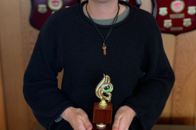 Keira Johnston with a trophy for her outstanding effort in finishing runner-up in the West Coast Region novice singles.