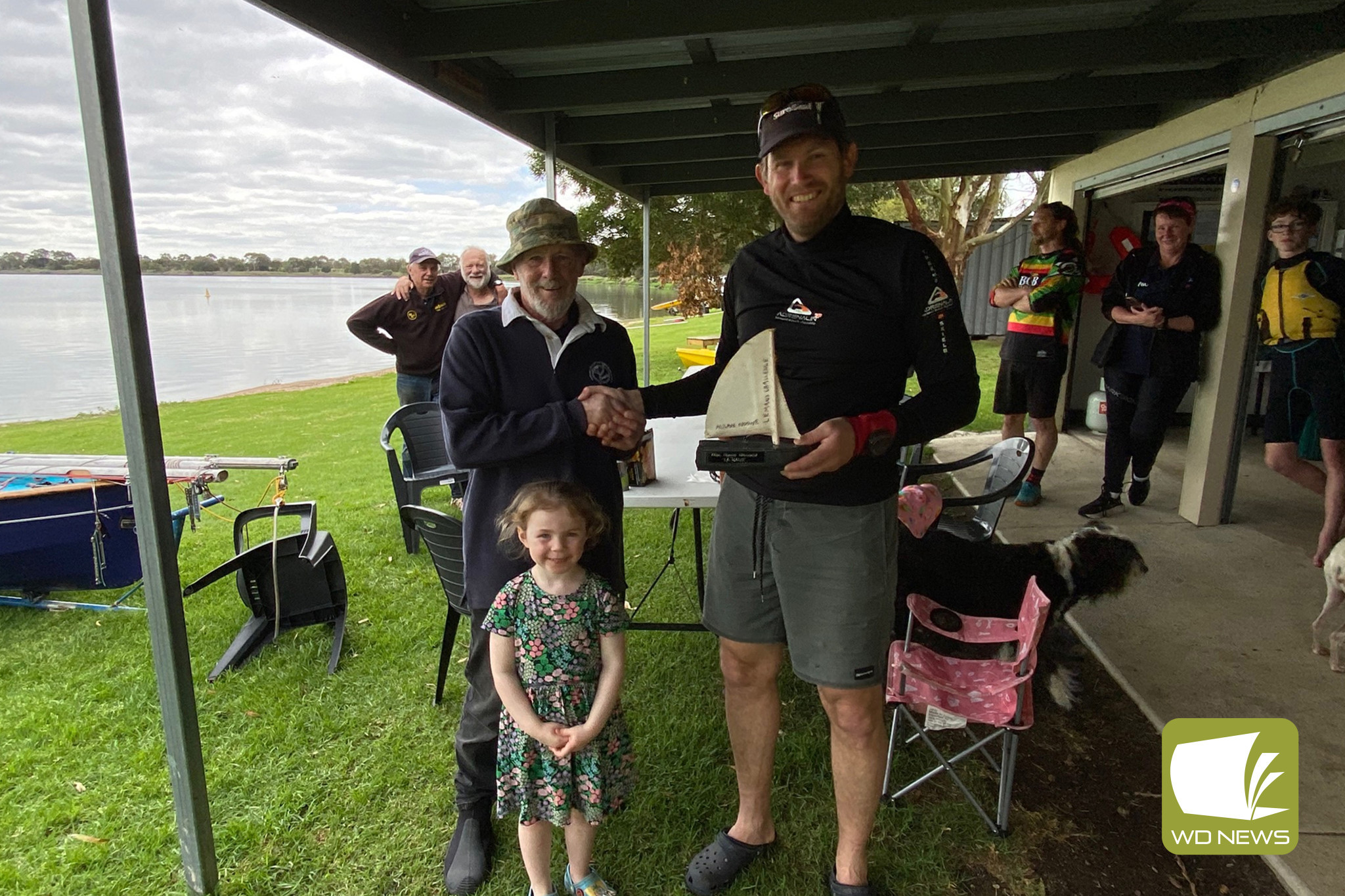 Young Molly Noone (centre) was excited to join club commodore Phil Noone (left) in presenting the Allan Noone Memorial award to last Sunday’s winner, Craig Wood.