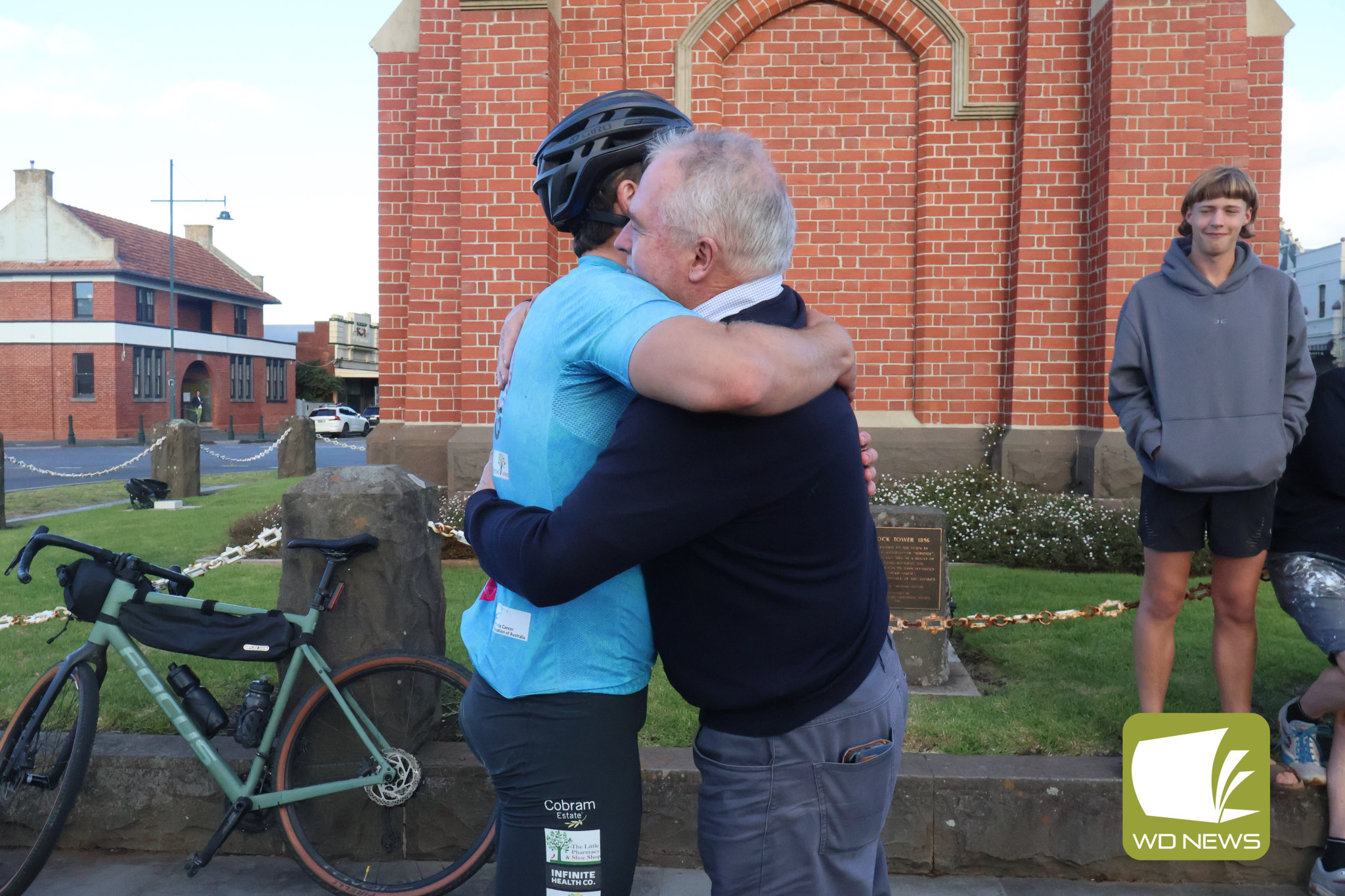 Family love: Jake was greeted by applause and family hugs once he reached the Camperdown Clocktower.