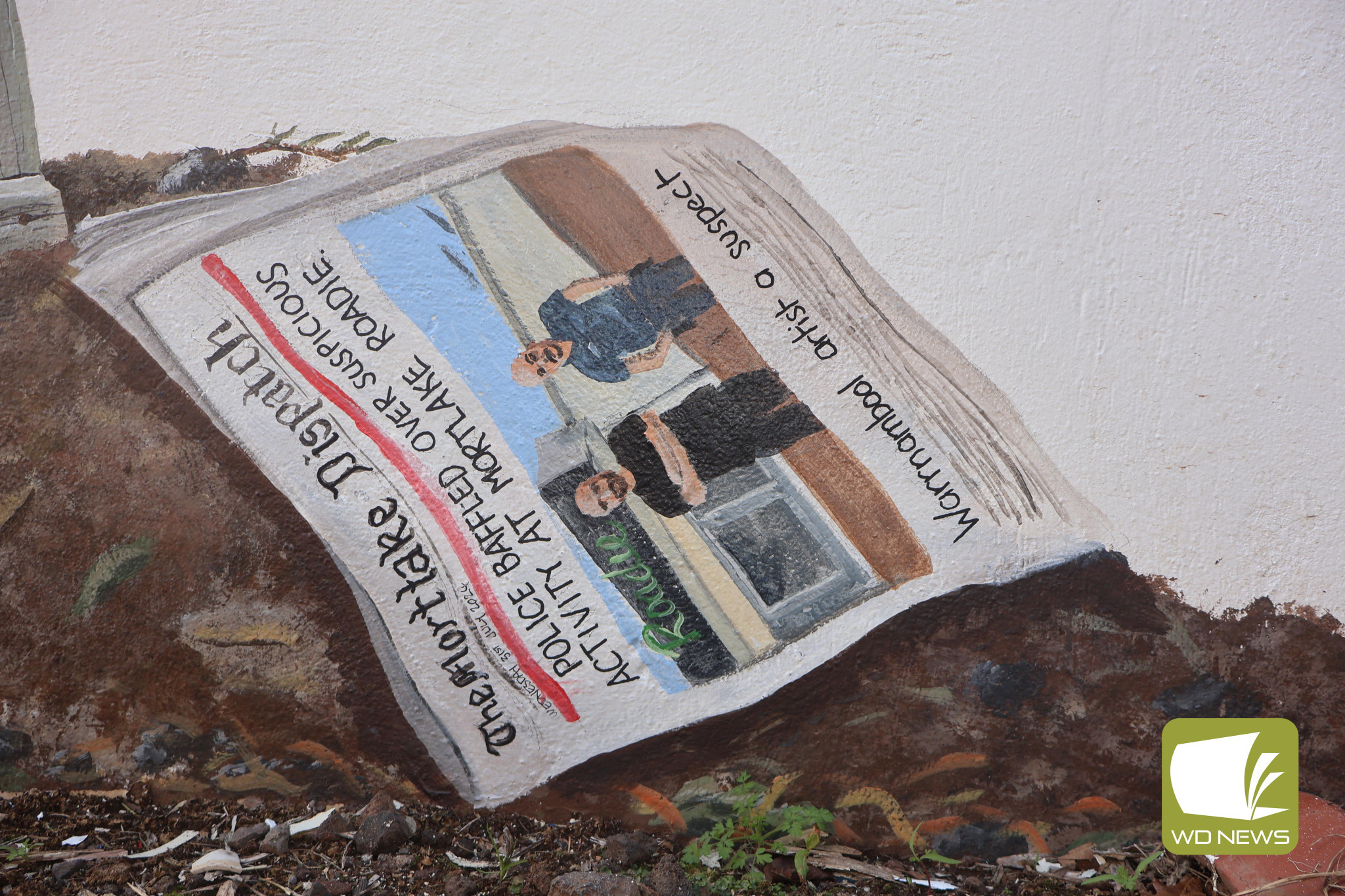 Not quite right: Among the additions to the mural was a front page of the Mortlake Dispatch, which replicated a story published earlier this year with a satirical twist. The image has been flipped for visibility.