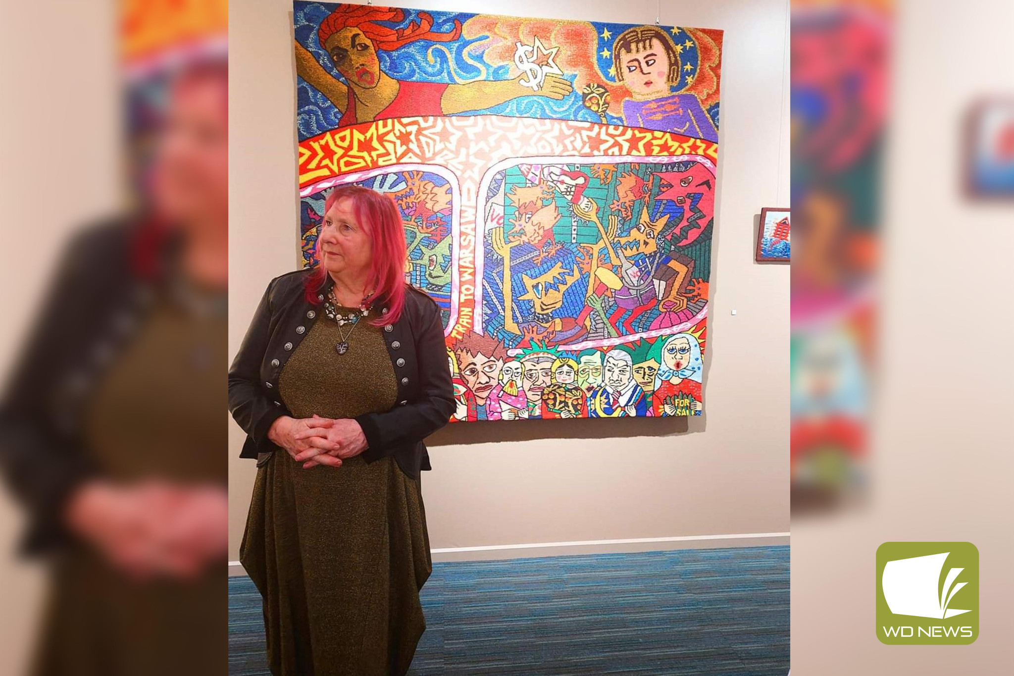 Coming together again: Camperdown-based artist Annie Keil-Taggart (pictured with Marie Cook’s work ‘Train to Warsaw’) was among the exhibiting artists at a Warrnambool exhibition last month.