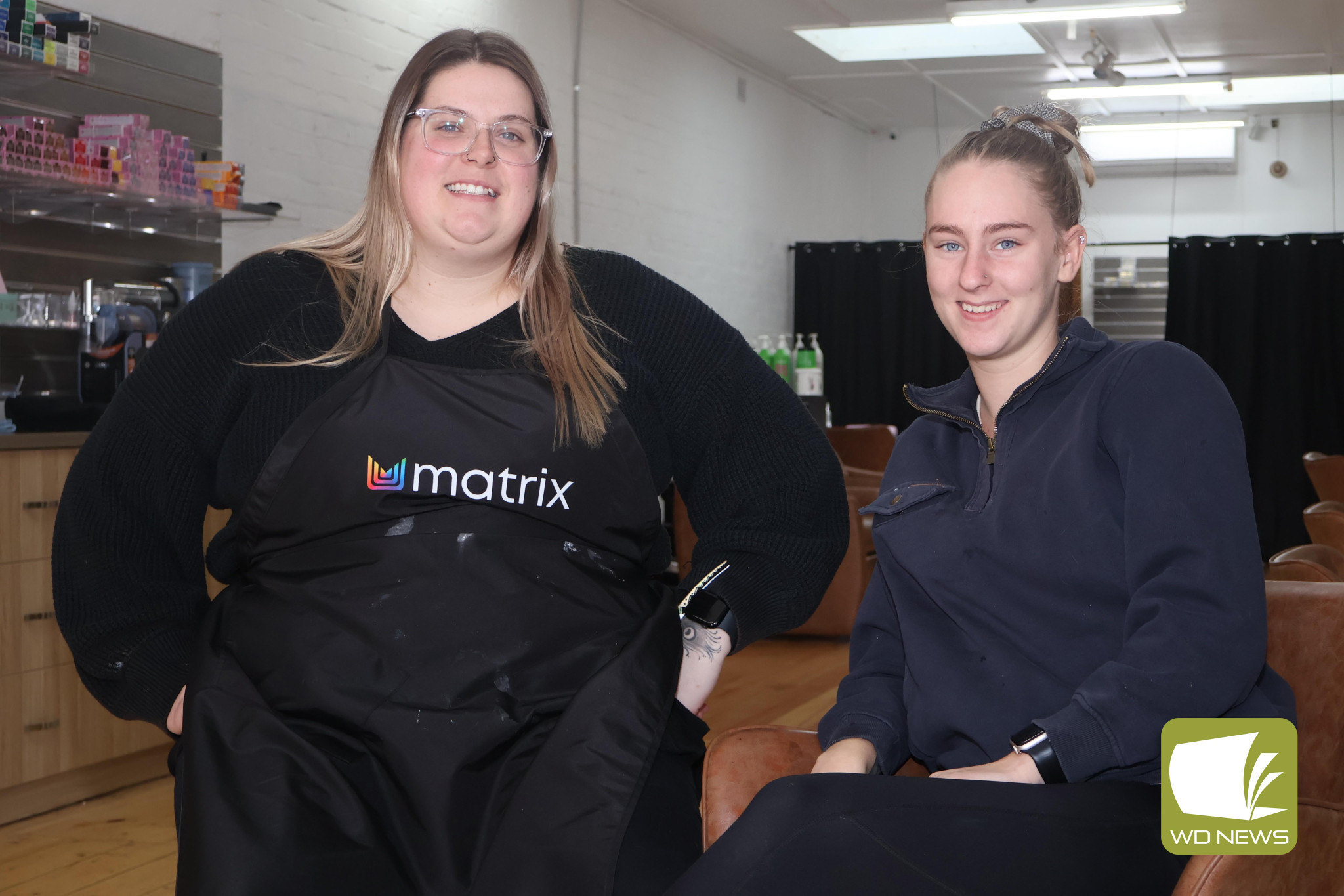 A small gesture: Knot Just Hair owner Emily Thorne, pictured left with beauty therapist Amelia Horan, is offering free haircuts every Saturday in support of farmers and Country Fire Authority volunteers.