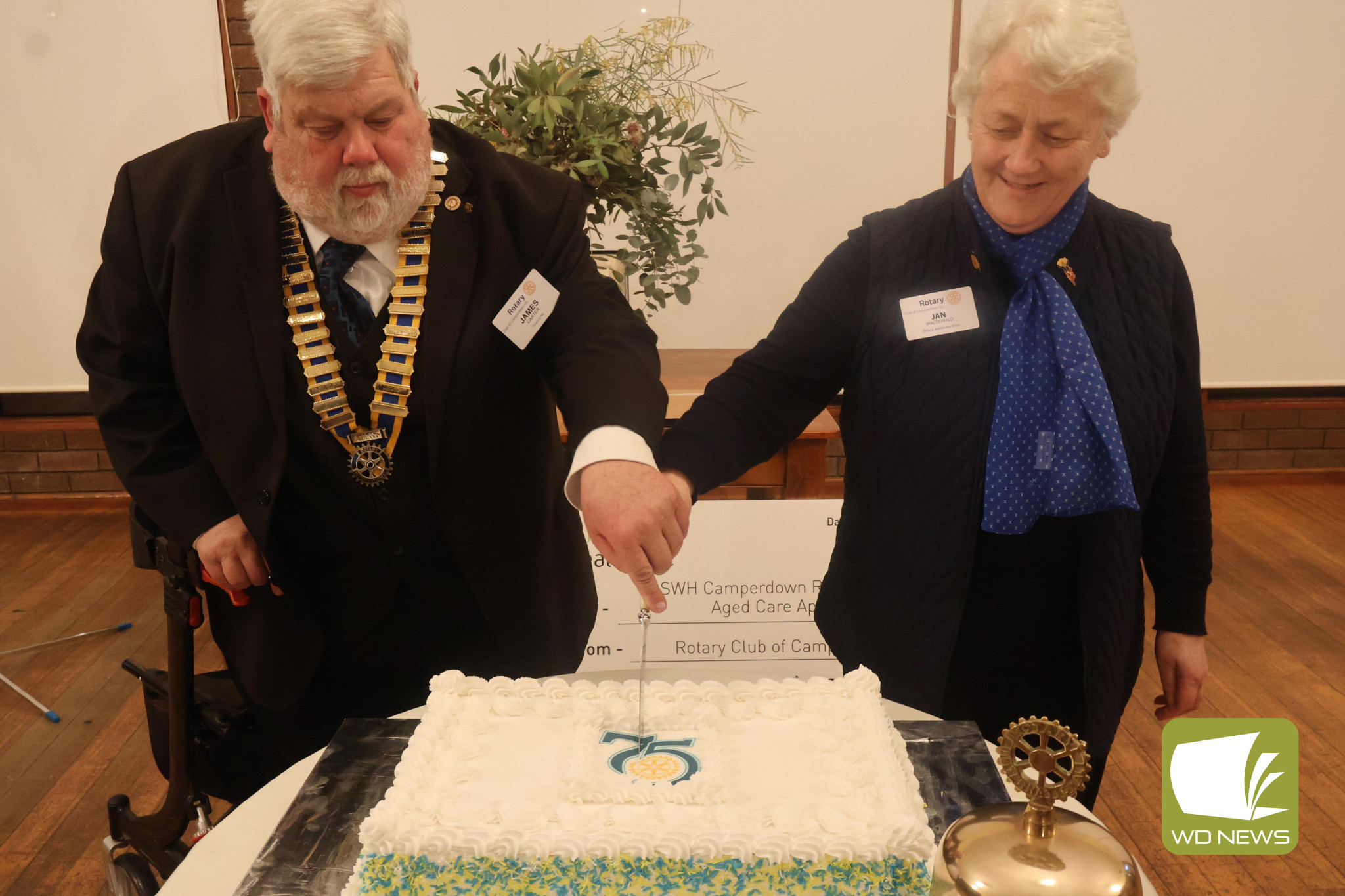 Major milestone: Former president James Carter and new president Jan MacDonald cut the Rotary Club of Camperdown’s anniversary cake last Saturday