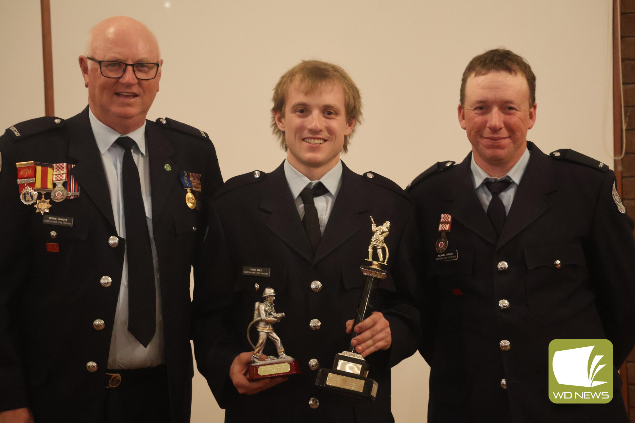 Highest honour: Camperdown CFA brigade member Leigh Ball (centre) was presented the Fireperson of the Year award by secretary, treasurer and communications officer Bernie Sinnott (left) and captain Michael Carman (right).