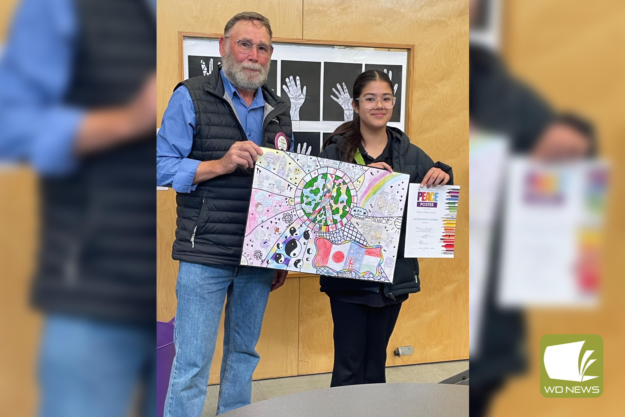 Unity: Cobden Primary School’s Amelia Katsaros with her winning entry as part of the Lions International Peace Poster Contest.