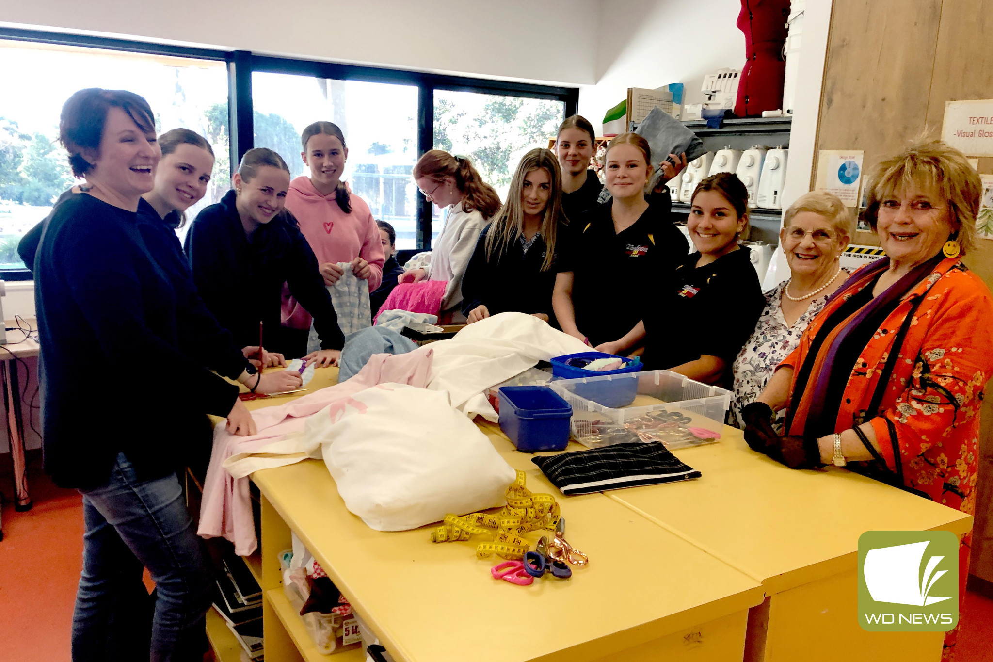 Linking generations: Timboon P-12 students and leaders meet with Timboon Opportunity Shop volunteers in a textiles class to prepare for the upcoming fashion day.