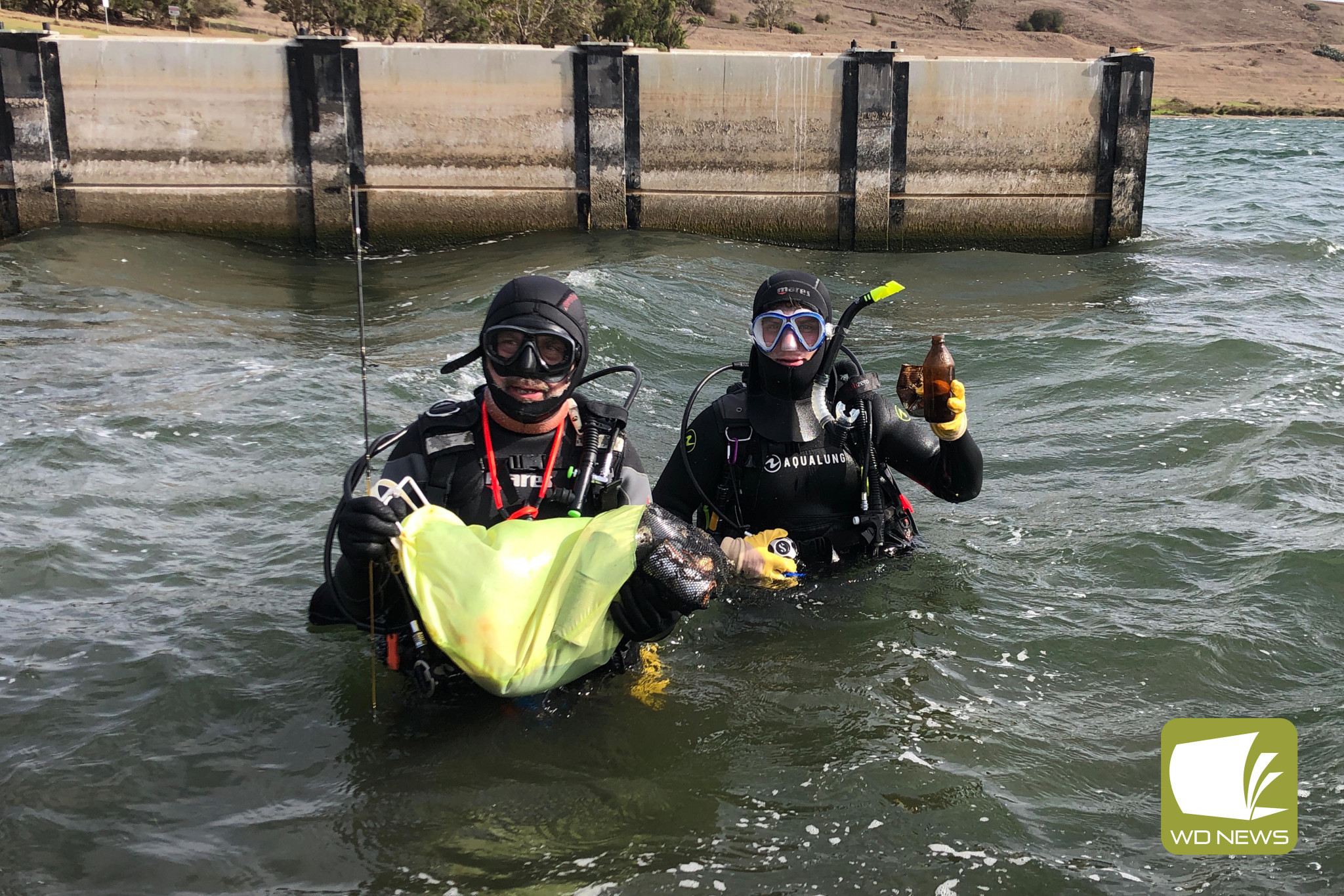 A clean act: Divers Steve Cooper (left) and Sean Kevans with some of their haul from last Sunday’s clean-up of Lake Bullen Merri.