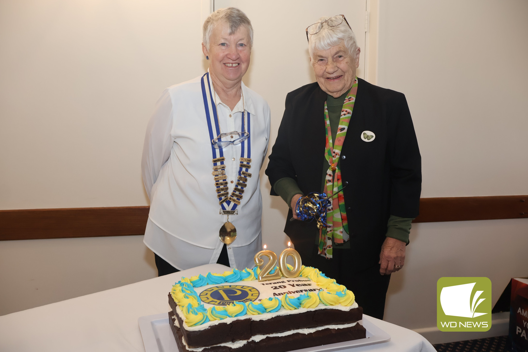 Milestone: Anne Gready and Dorothy Whiting cut the cake to celebrate the 20-year anniversary of the Terang and District Probus Club on Monday.