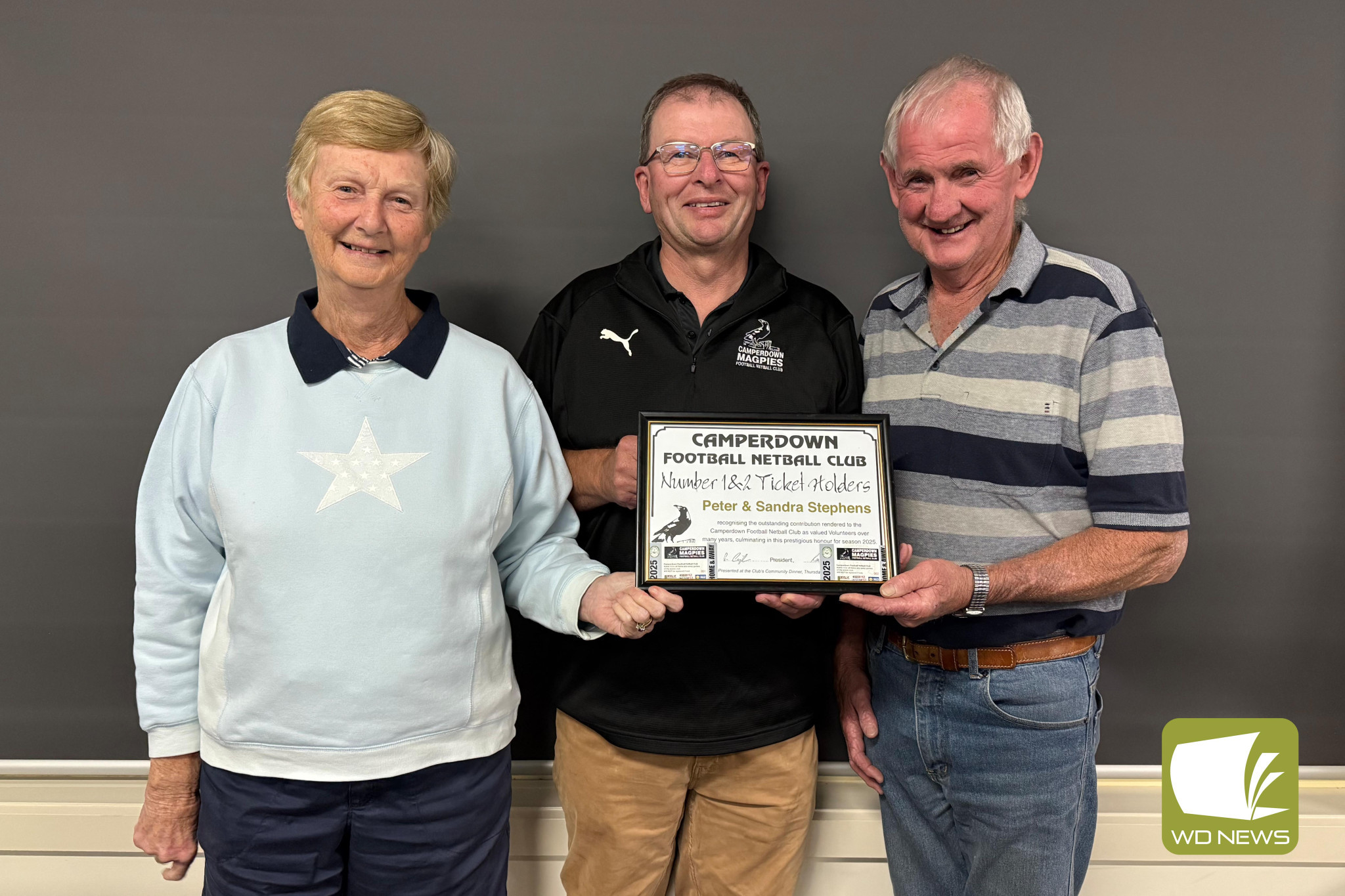 Vale: Peter Stephens (right), pictured with wife Sandra and Camperdown Football Netball club president Phil Cunningham receiving number one and two ticket holder status earlier this year.