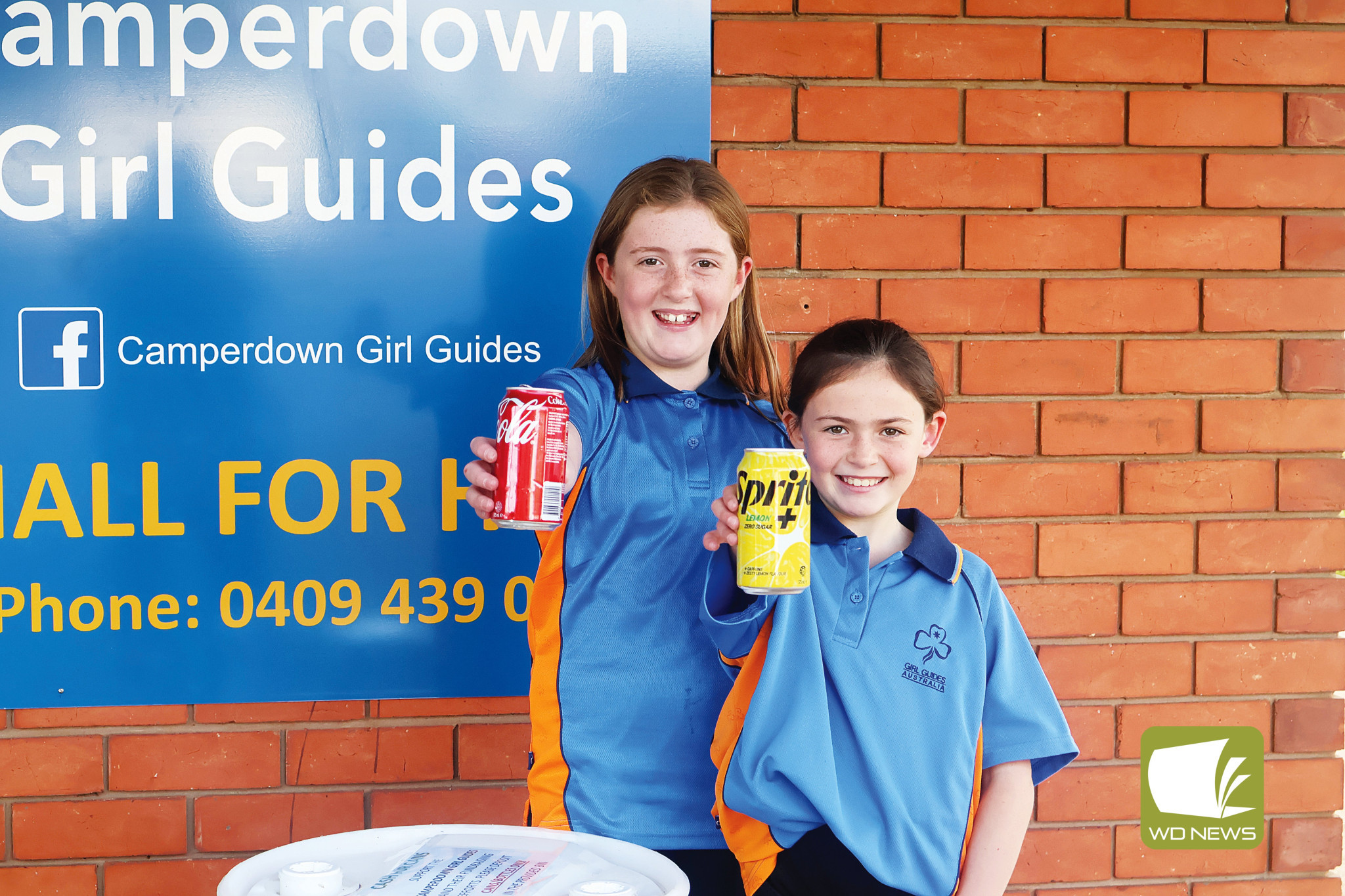 Cash for cans: Camperdown Girl Guides Grace and Olivia Barber are encouraging residents to collect their empty bottles and cans and give them to the group to help raise funds to run the hall.