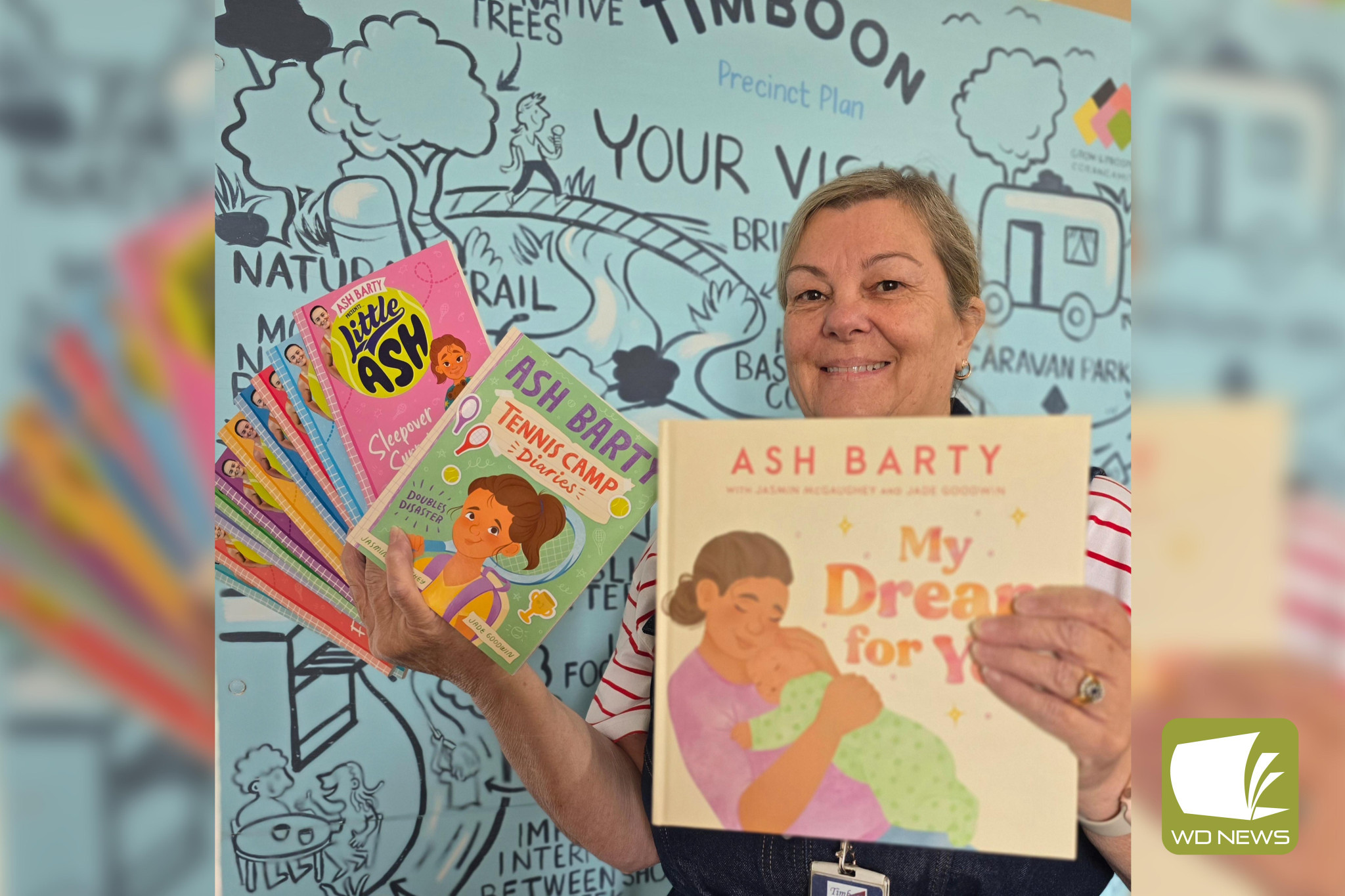 Happy reading: Timboon library’s Andrea Clarke shows off an Ash Barty book prize pack young readers could win this summer by signing up to the BIG Summer Read.