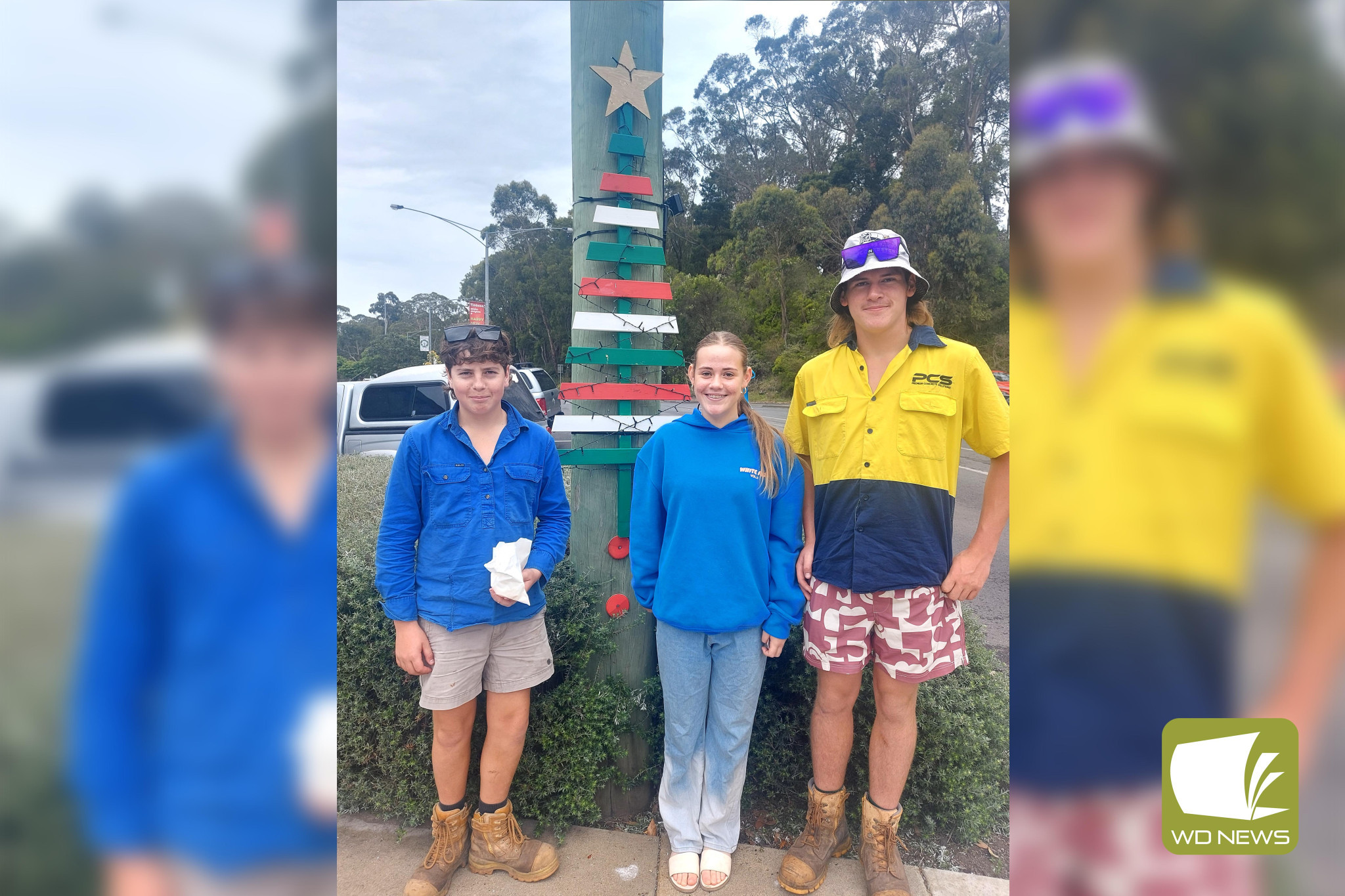 Christmas spirit: Nate Sambell, Logan Lyne and Tyra Sambell admire some of Timboon’s Christmas decoration.