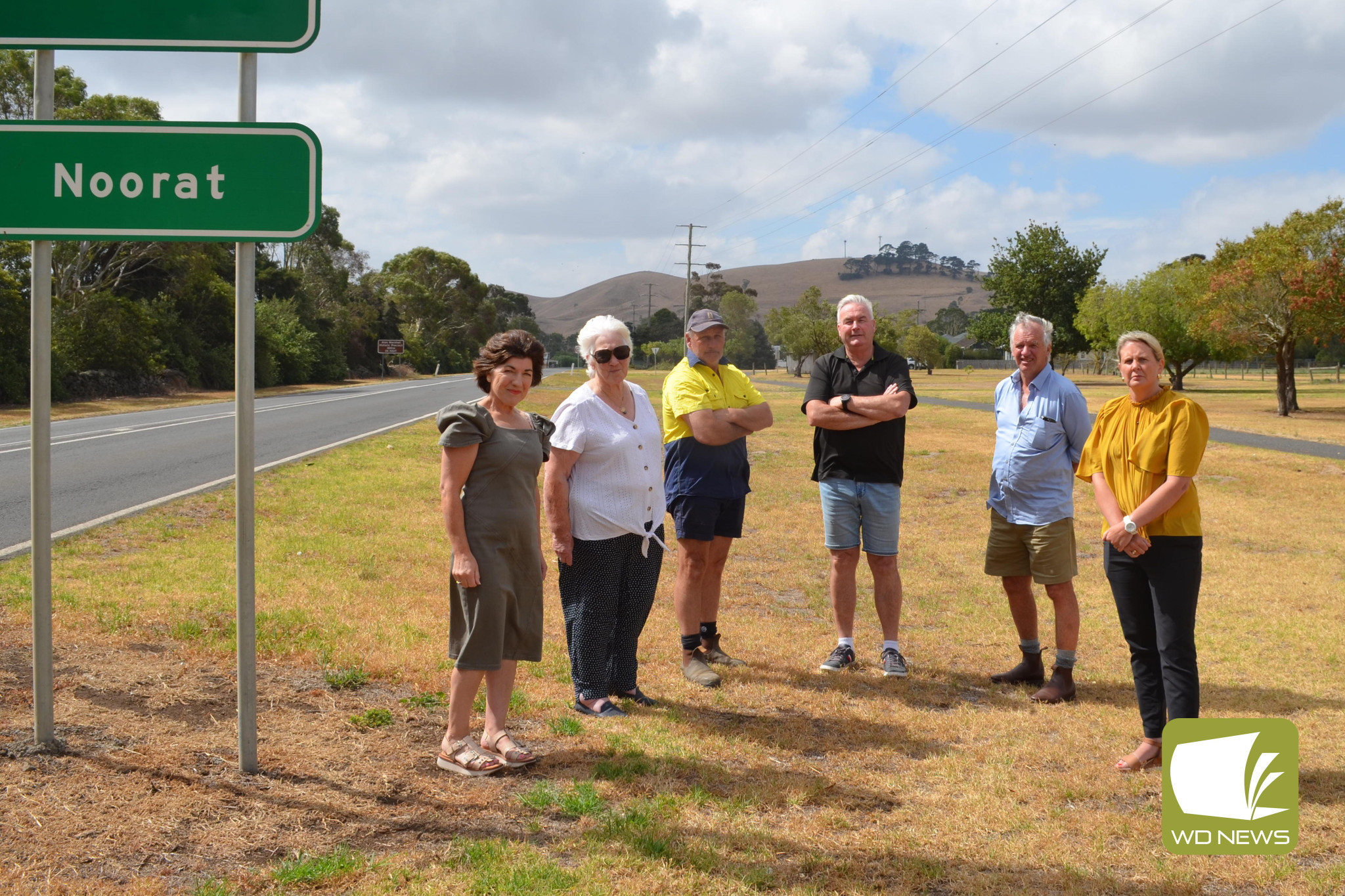 Not good enough: Corangamite Shire councillors and Noorat-area residents have joined to call on Telstra to stop dragging its feet on delivering much-needed communications upgrades, despite the corporate giant having received significant taxpayer funds to do so. Pictured are Cr Geraldine Conheady (from left), Lynn Patzel, Shane Quick, deputy mayor Laurie Hickey, Cr Nick Cole and Cr Jo Beard, with existing communications towers on Mt Noorat in the background.