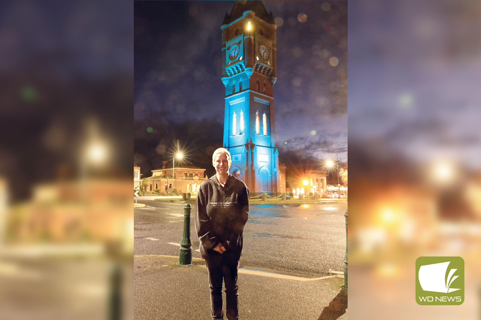 Lighting up: Callani Winsall in front of the Camperdown clocktower, which was lit up in teal to mark Tourette’s Awareness Week last week.