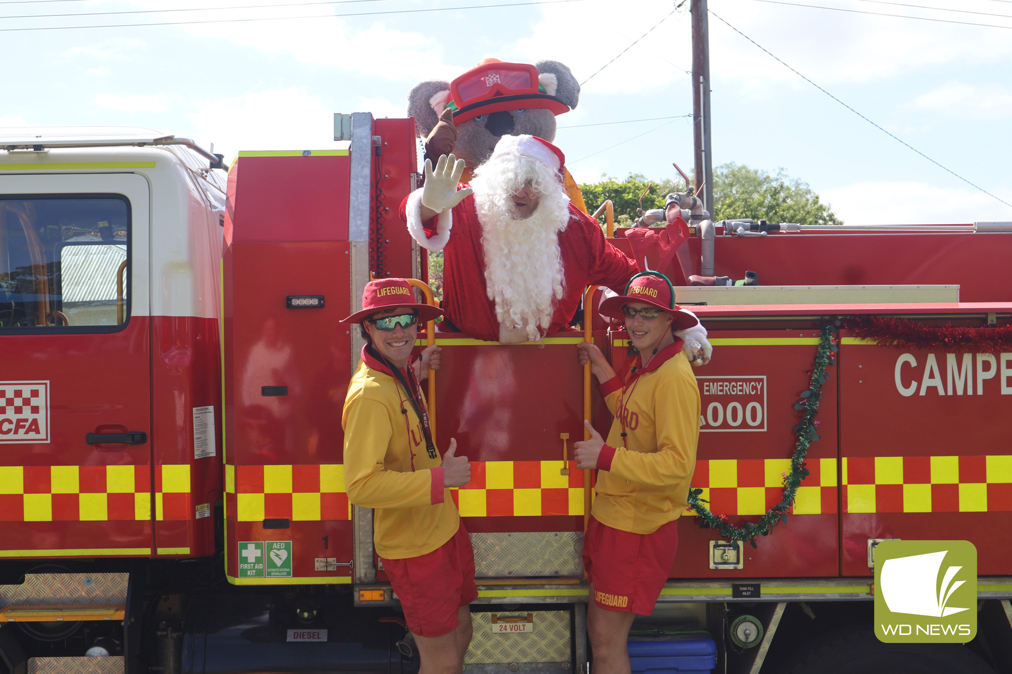 Never too old: Camperdown Pool lifeguards Hugh Mason and Taj Cunningham proved that no-one is too old to be excited by Santa’s visit.