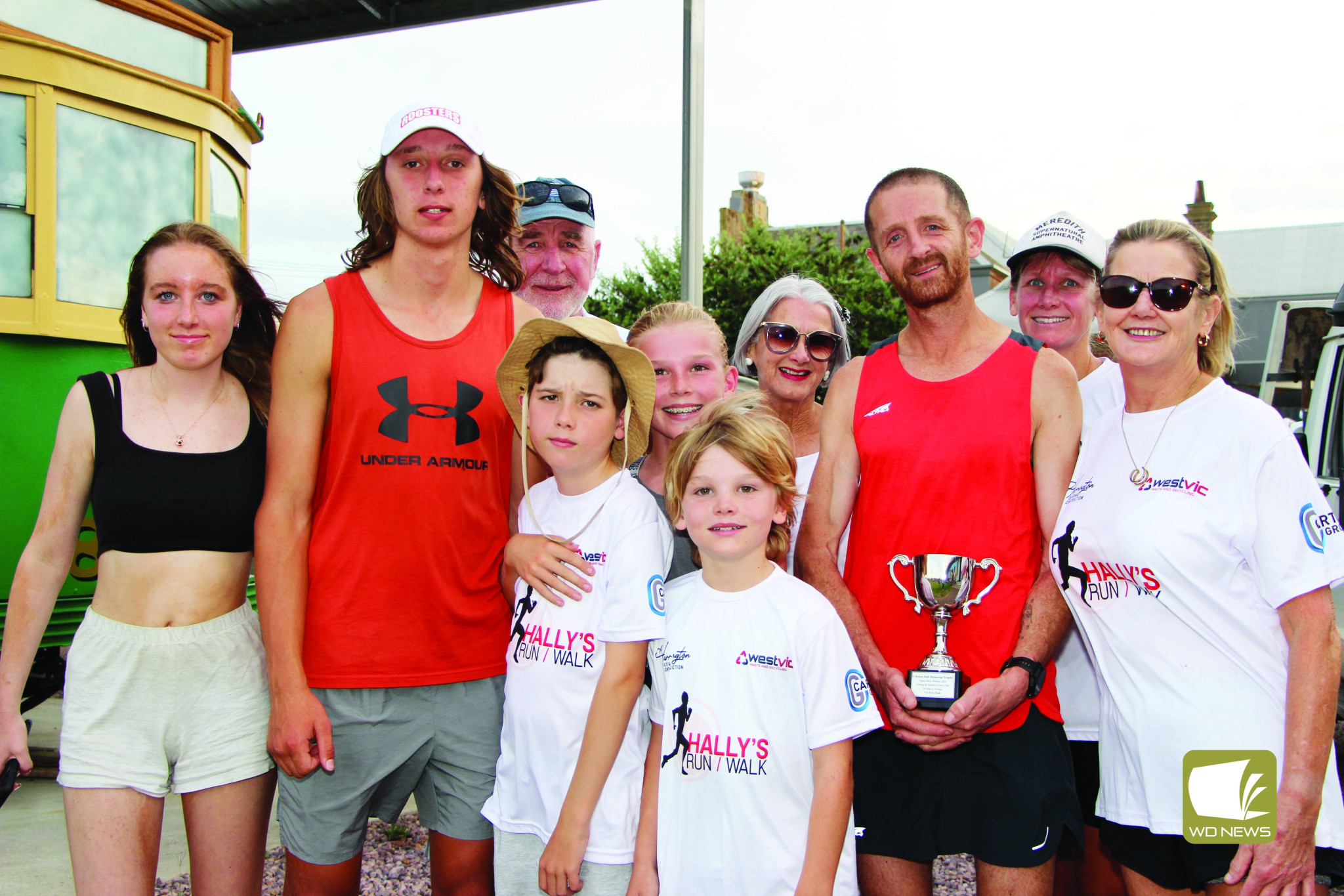 In memory of Hally: Terang and District Lions Fun Run and Walk winner Ben Wallis received the 2023 trophy named in the honour of six-time event winner Clinton Hall. Mr Wallis is pictured with the family of Clinton Hall.