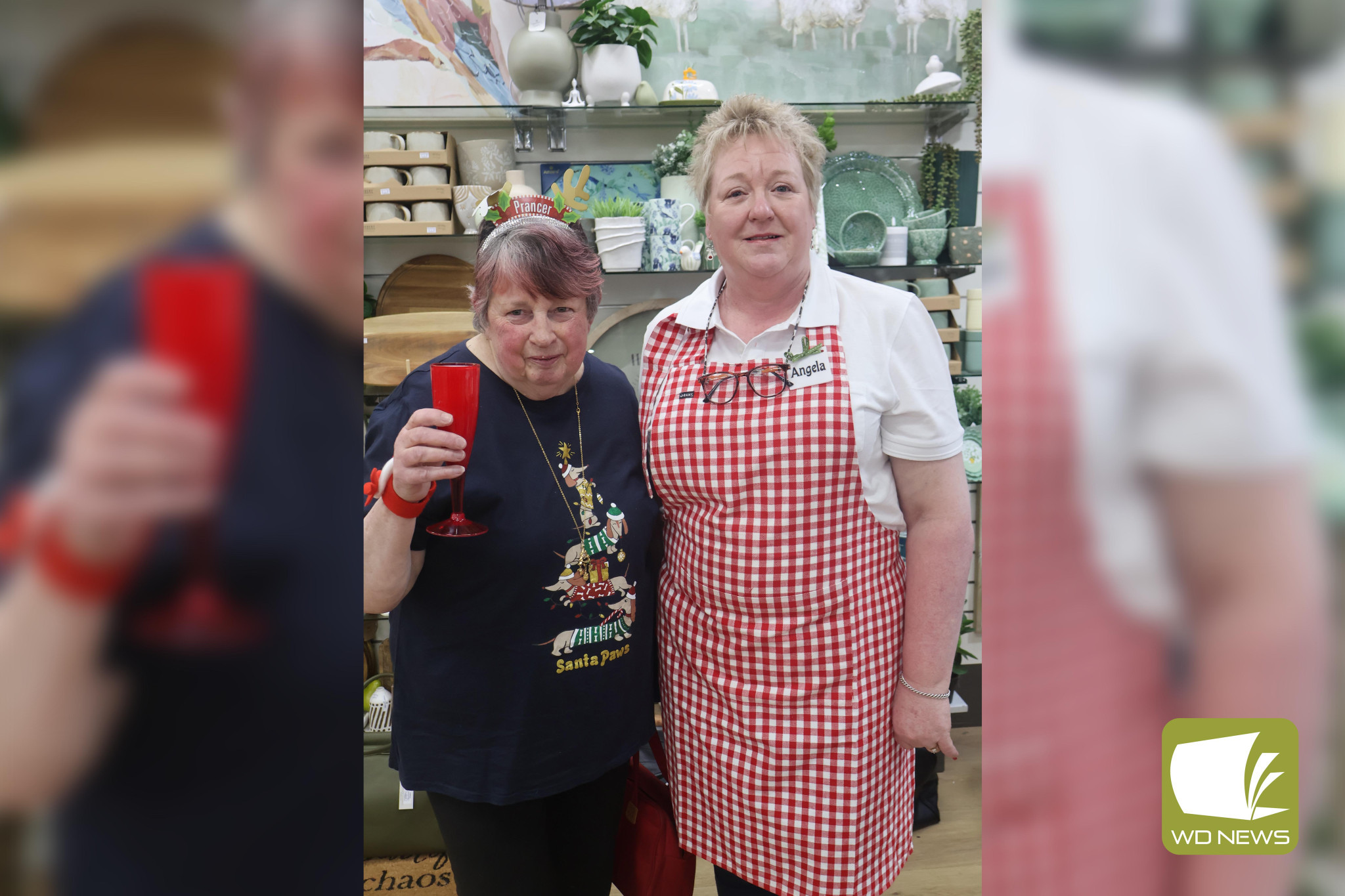 Festive flair: While the pharmacy was decked out in Christmas decorations, one attendee (Joan Bux, pictured with Angela Molloy) went all out to mark the countdown to Christmas.