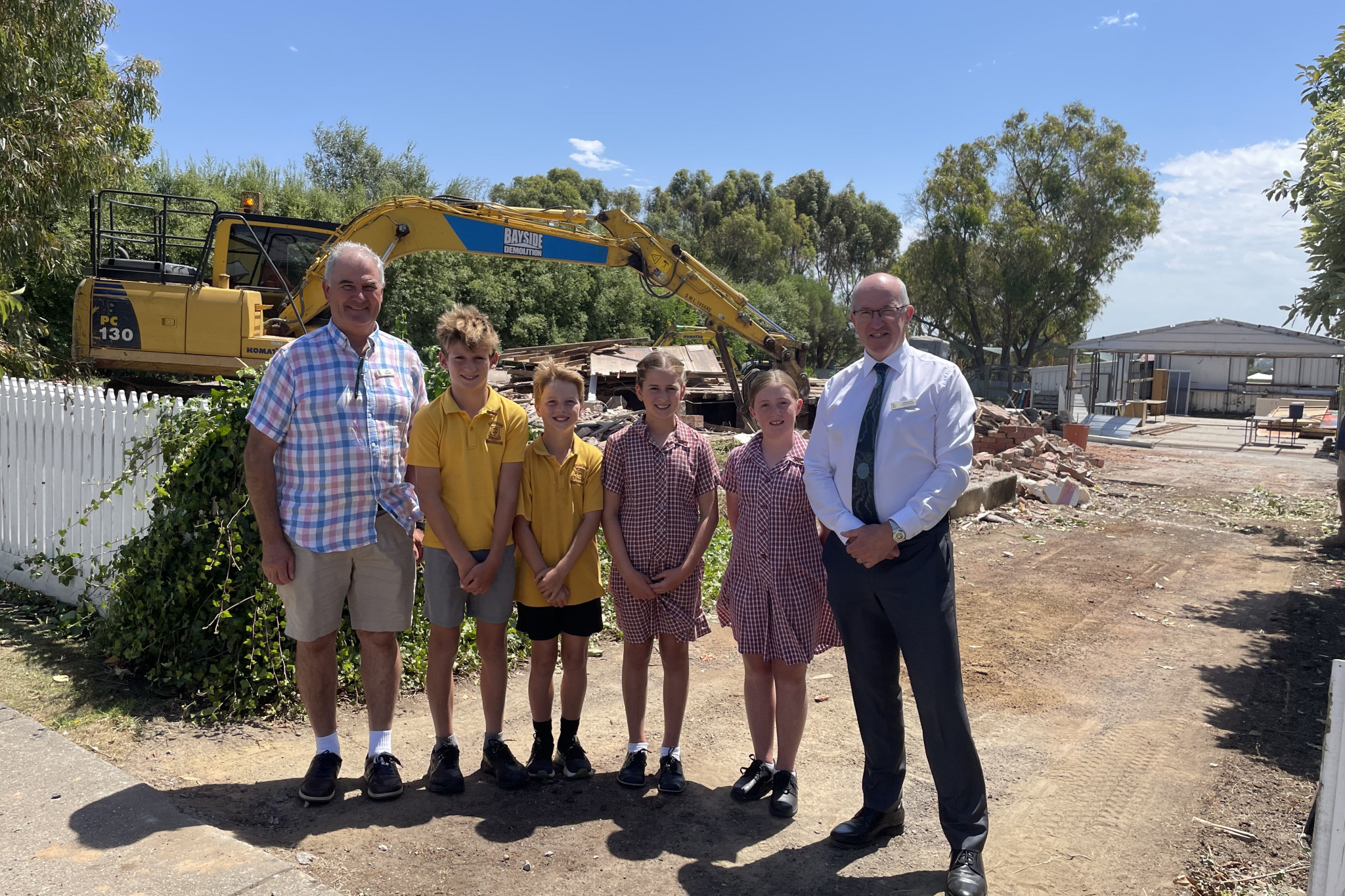Project begins: St Patrick’s Primary School principal Tim Bourke, school captains Vince Titmus, Rhys Darcy, Steph Fleming and Grace Barber with executive director of Catholic education, Ballarat Diocese look on as work begins on a new senior school wing.