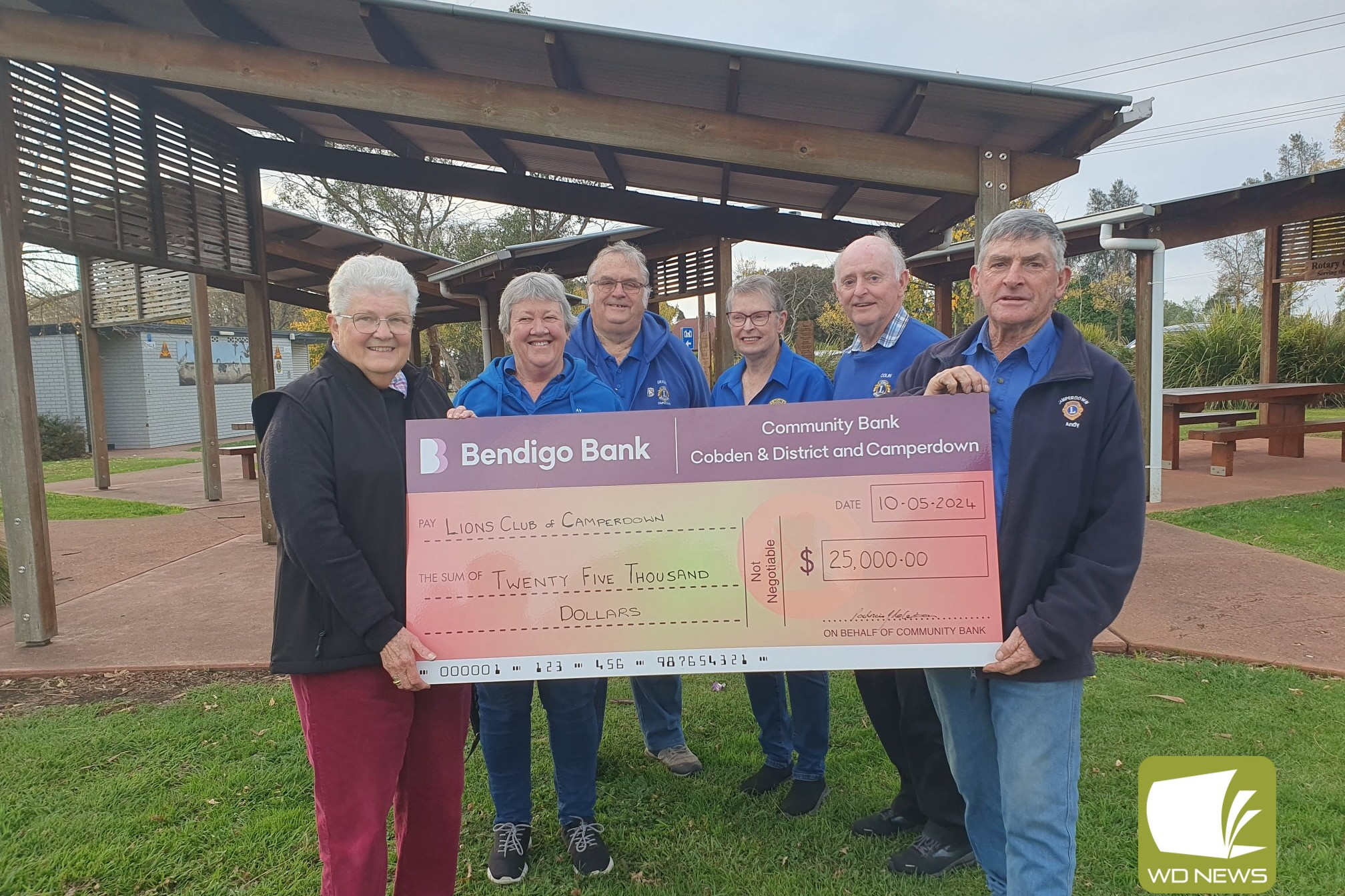 Support appreciated: Cobden and District Community Bank board chair Pat Robertson presents Lions Club of Camperdown members with a cheque for $25,000 toward their fundraising campaign for an all-abilities carousel.