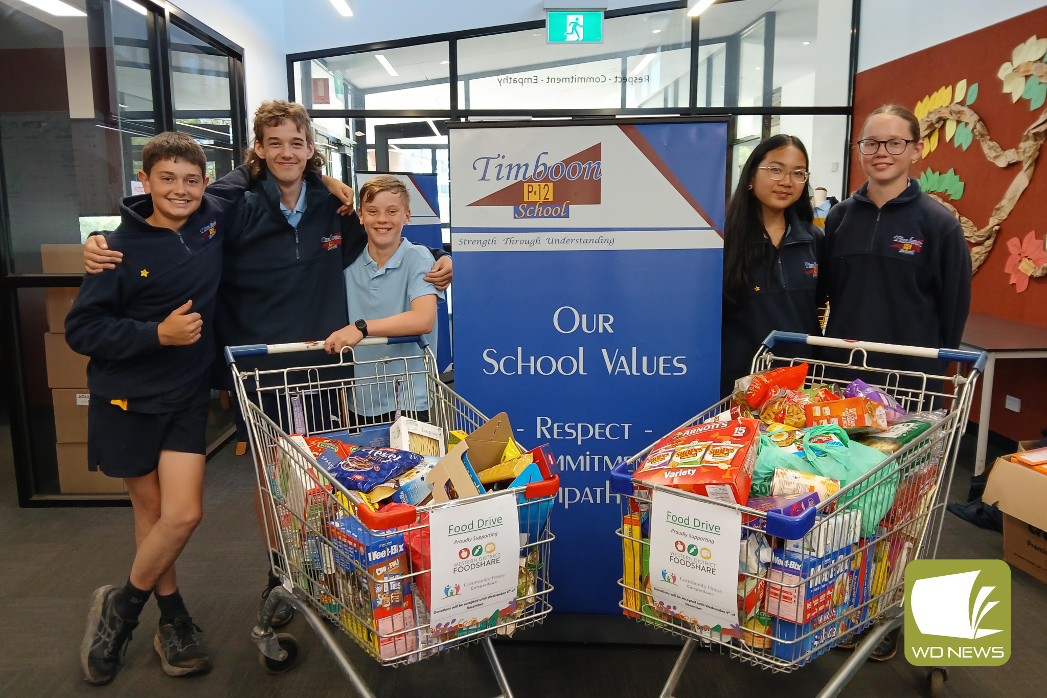 Helping others: Timboon P-12 School Year 7 students Jack Couch, Lucas Woolstencroft, Riley Stephens, Maria Dela Cruz and Ellen Whiting help package up donation contributed by the school community to Corangamite Food Bank.