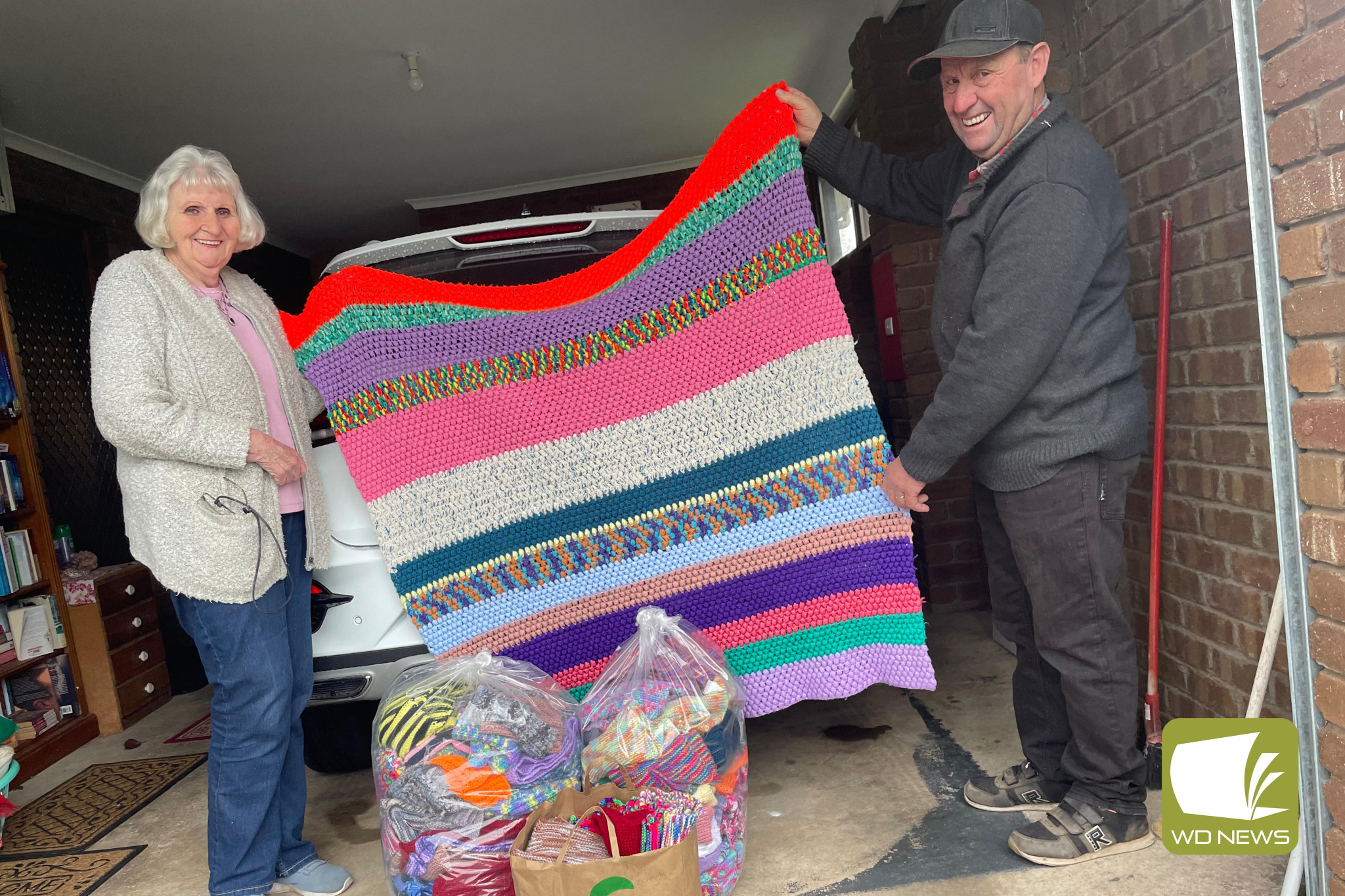 Helping out: Cobden Conference of St Vincent De Paul member’s Pam Savage and Paul Dwyer prepare to deliver close to 300 knitted items to those in need in Melbourne