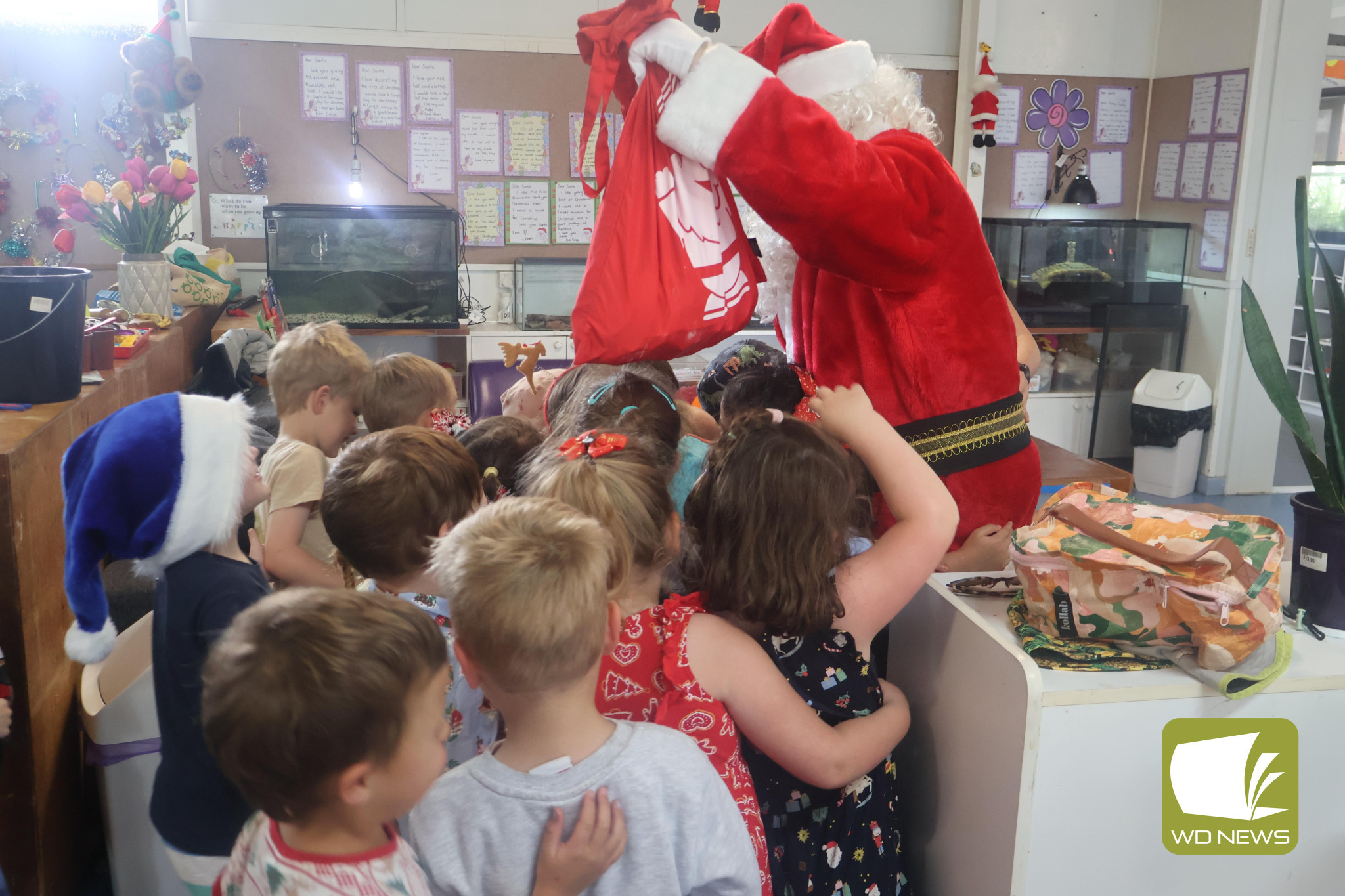 Joy of Christmas: Children at Baranbali kindergarten raced to greet Santa Claus when he visited last Thursday.