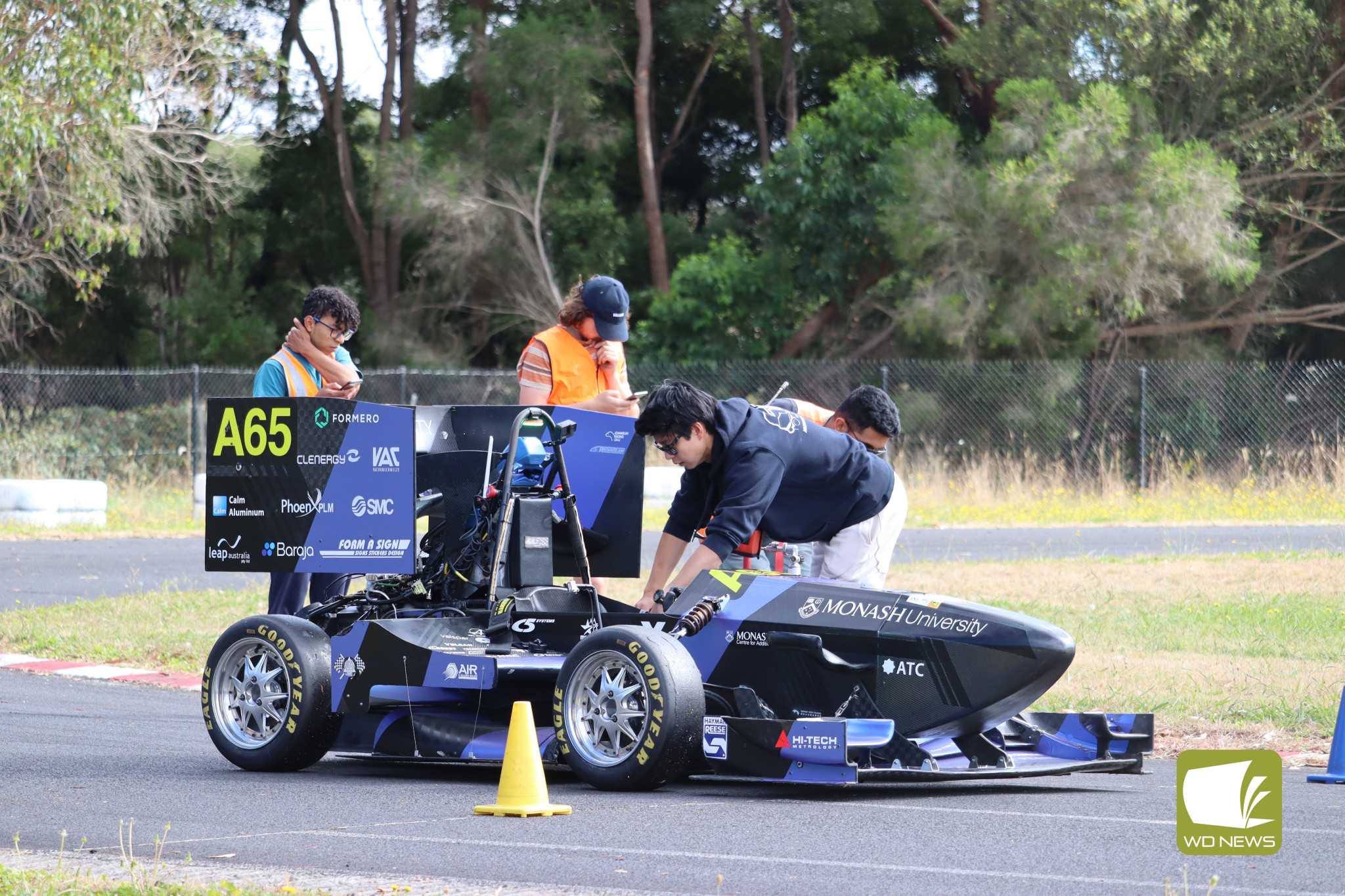 Testing: Members of the Monash Motorsport work on an autonomous race car at Cobden on Friday.