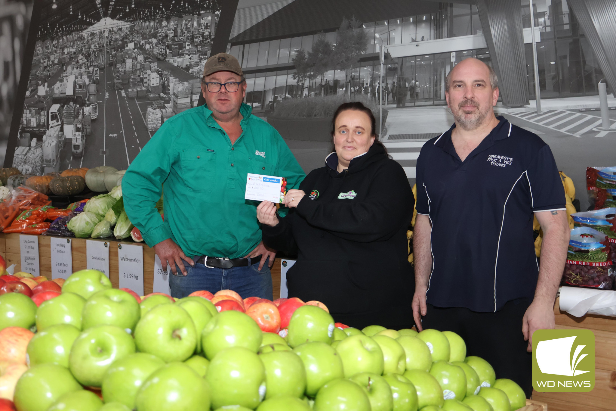 Winning ticket: Jason Krepp (left) was named the lucky winner of a $200 voucher under a promotion designed to support family-operated fresh fruit and vegetable grocers. He collected on his winnings over the weekend, pictured with Greavesys Fruit N Veg owners Cassie and Jason Greaves.