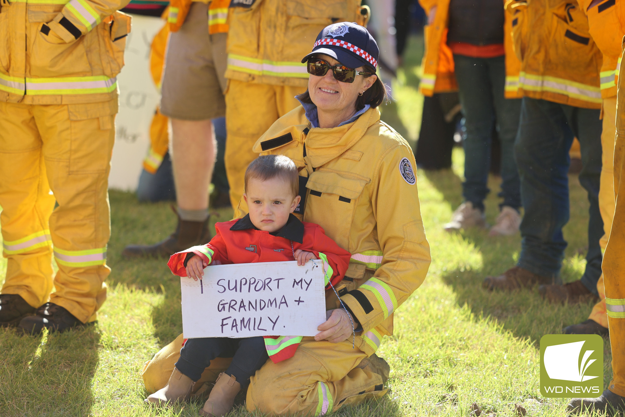 United front: Volunteers from across the region gathered in Camperdown and Warrnambool this week to protest the Victorian Government’s Emergency Services and Volunteers Fund, which will smash property owners with higher taxes. CFA Mortlake group officer Merrilyn McCosh, pictured at the Warrnambool rally with grandson Tex, was among those uniting for fairness.